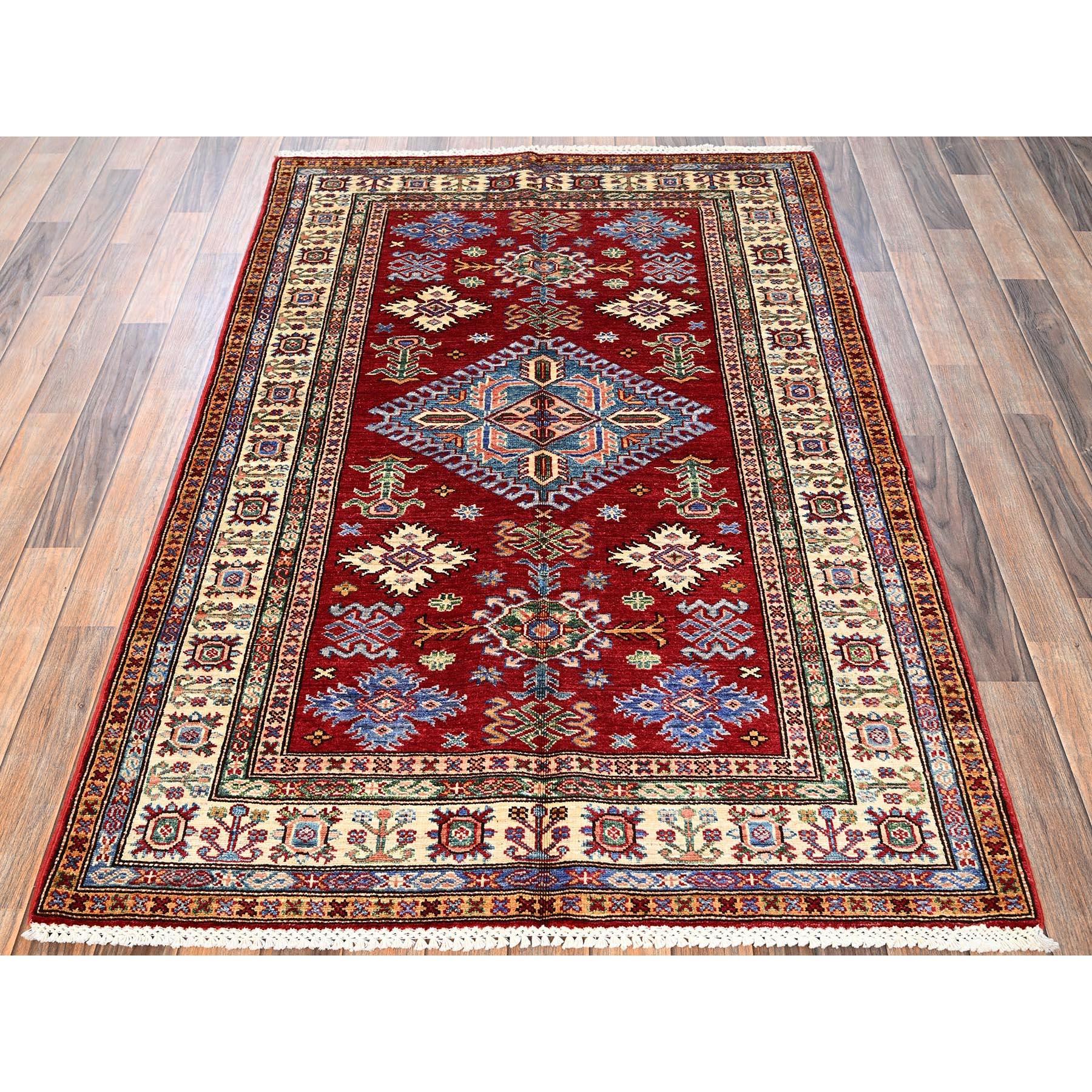 Ruby Red, Afghan Super Kazak with Geometric Medallion Design, Hand Knotted, Pure Wool, Vegetable Dyes, Oriental Rug
Primary materials: Wool
Latex: No Pile 
height: 0.25 Inches
Style: Traditional
Primary color: Red
Secondary colors: Blue, Peach,