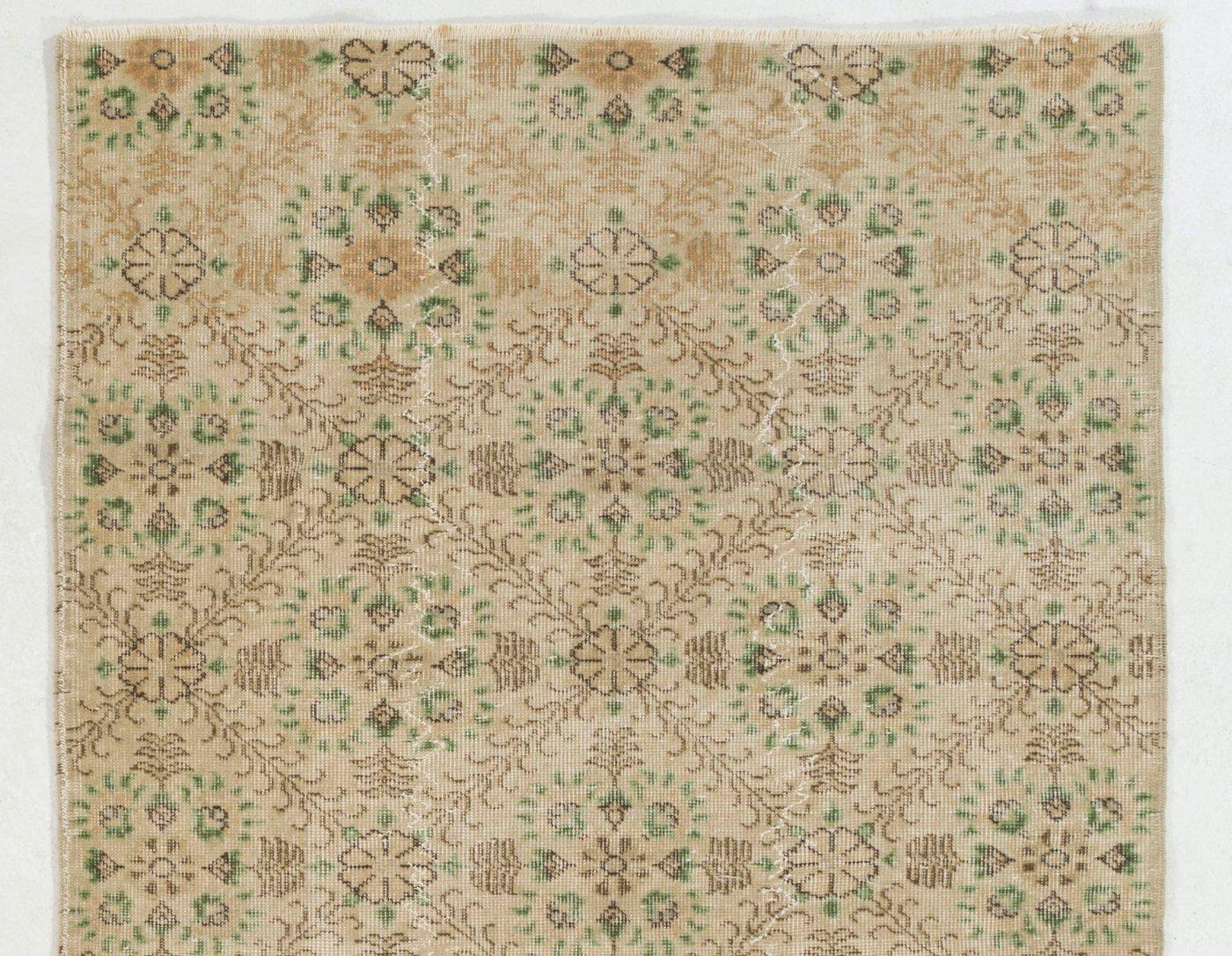 A vintage hand-knotted rug from Central Turkey with a well-drawn design of all-over floral lattices in softly glowing tones of very light peach and beige as well as forest green and brown . 

The rug is finely hand-knotted with even medium wool pile