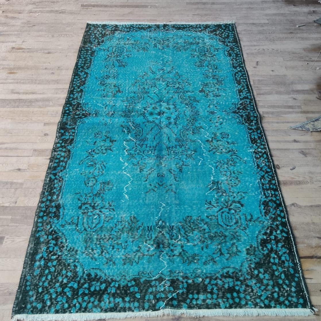 A vintage Turkish rug over-dyed in teal color for contemporary interiors.
The rug is finely hand-knotted, has low wool pile on cotton foundation. It is in very good condition, professionally washed, sturdy and suitable for areas with high foot