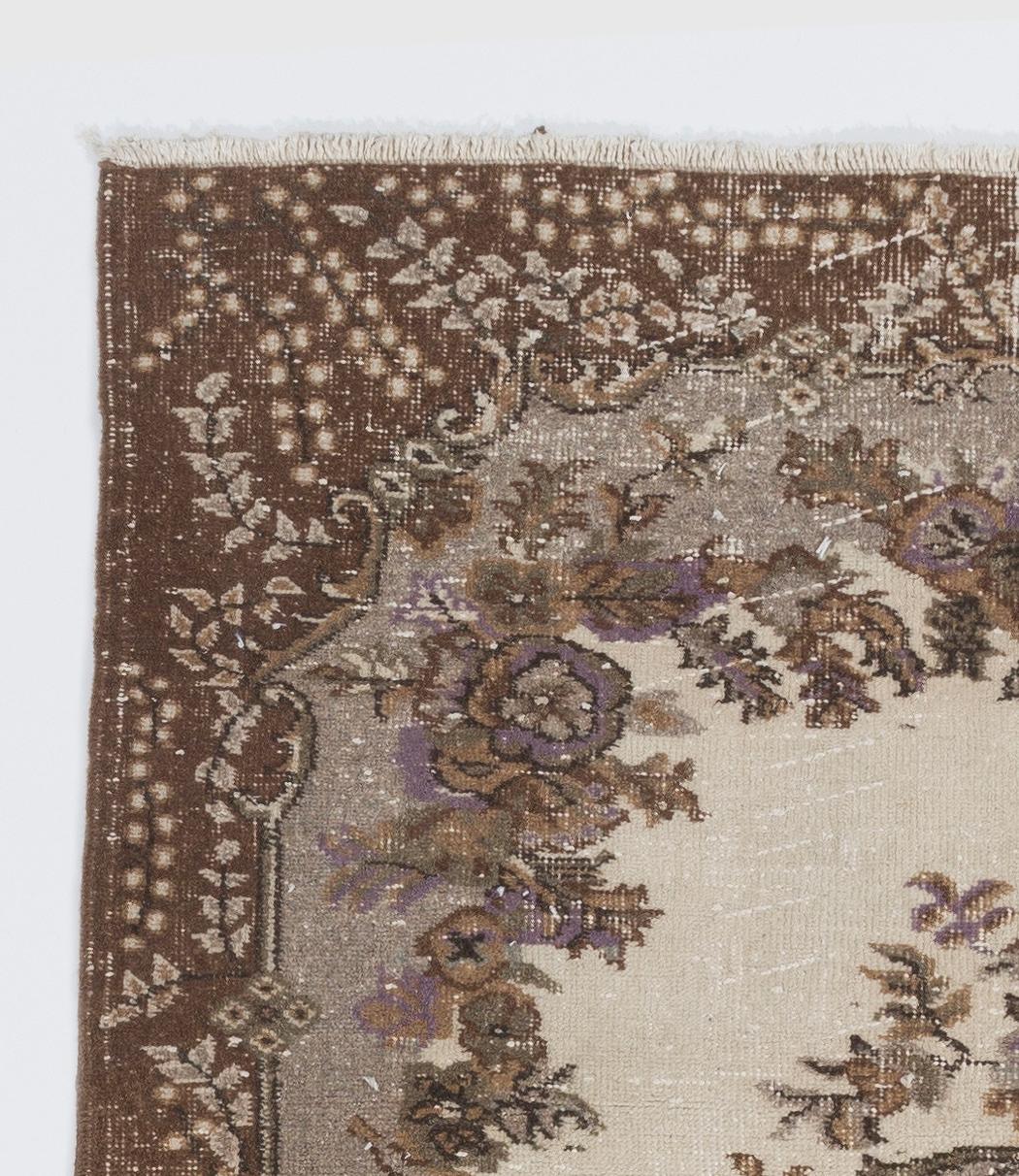 A vintage Turkish accent rug in beige, brown, lilac and green colors. Measures: 4 x 7 ft.
Finely hand knotted, low wool pile on cotton foundation. Deep washed.
Sturdy and can be used on a high traffic area, suitable for both residential and