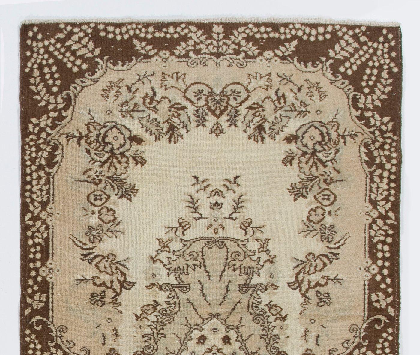 A vintage Turkish accent rug. The rug features a floral medallion design in a field decorated with floral motifs.  It has low distressed wool pile on cotton foundation, is in very good condition, sturdy and clean as a brand new rug. Measures: 4 x 7