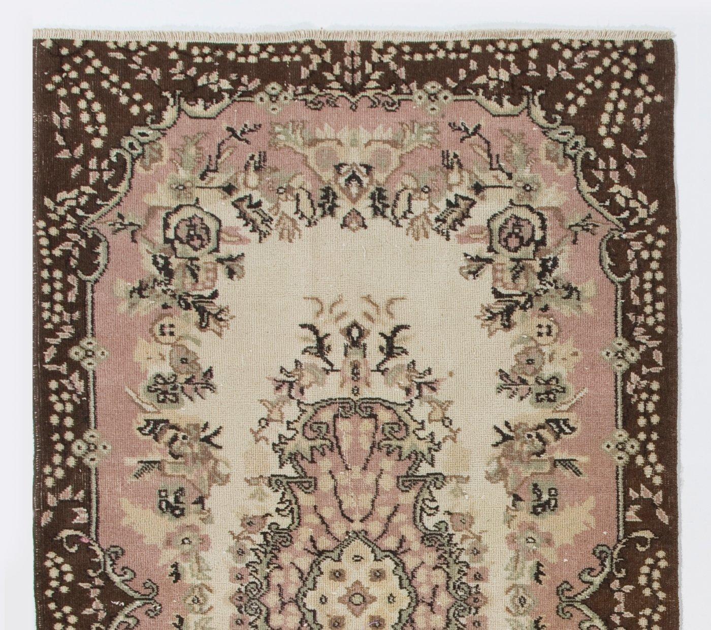 A finely hand-knotted vintage Turkish carpet from 1960s featuring a floral medallion design. The rug has even low wool pile on cotton foundation. It is heavy and lays flat on the floor, in very good condition with no issues. It has been washed