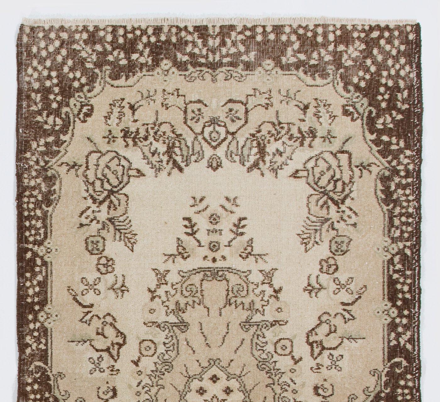 A hand-knotted vintage Turkish accent rug. The rug features a floral medallion design in a field decorated with floral motifs. It has low distressed wool pile on cotton foundation, is in very good condition, sturdy and clean as a brand new rug.