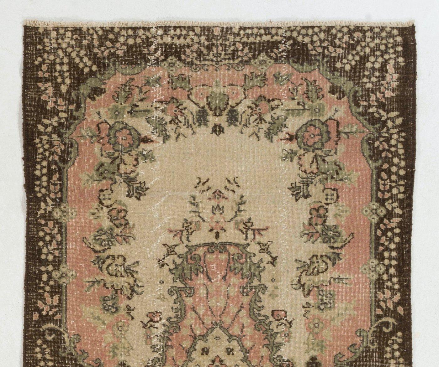 A finely hand-knotted vintage Turkish carpet from 1960s featuring a floral medallion design. The rug has even low wool pile on cotton foundation. It is heavy and lays flat on the floor, in very good condition with no issues. It has been washed
