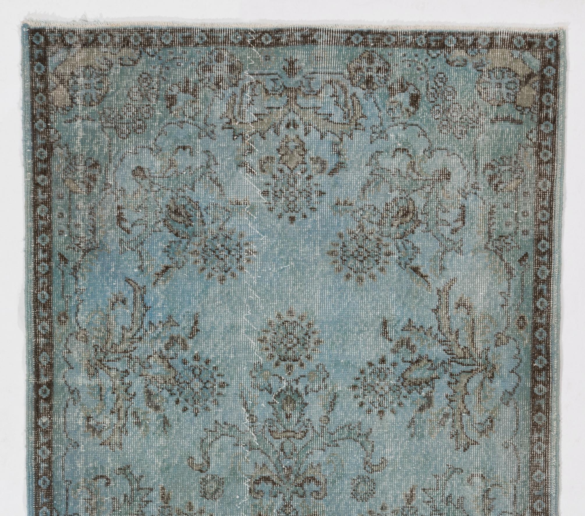 A vintage Turkish area rug re-dyed in blue color for contemporary interiors. Measures: 4 x 7.3 Ft.
Finely hand knotted, low wool pile on cotton foundation. Professionally washed.
Sturdy and can be used on a high traffic area, suitable for both