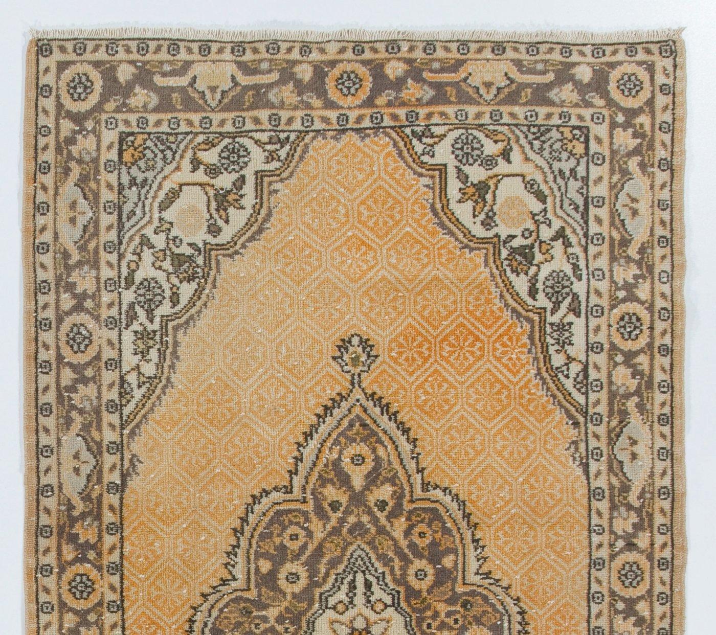 A finely hand-knotted vintage Turkish carpet from 1960s featuring a geometric medallion design. The rug has even low wool pile on cotton foundation. It is heavy and lays flat on the floor, in very good condition with no issues. It has been washed