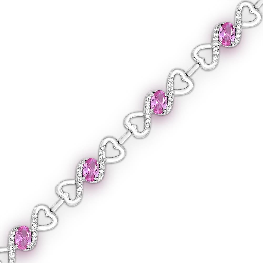 This stunning bracelet features 7 oval-cut created pink sapphire accented by 98 pieces of bright round created white sapphire gemstones, delicately set in a high-quality sterling silver creative double-open heart chain with a secure lobster closure.