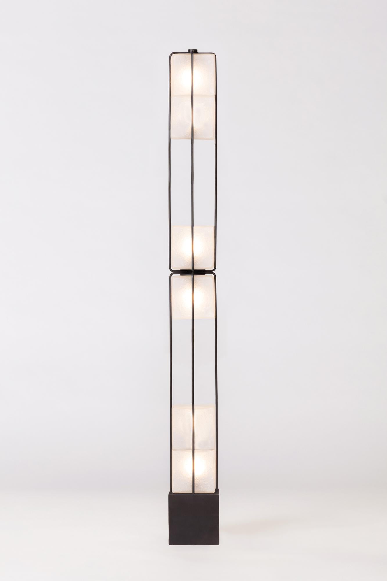 The Alice collection is inspired by Brutalist modular architecture. The textured handblown glass cubes are sandblasted to create a soft glow and stacked together to diffuse light in different intensities. The frame is made of solid brass, finished