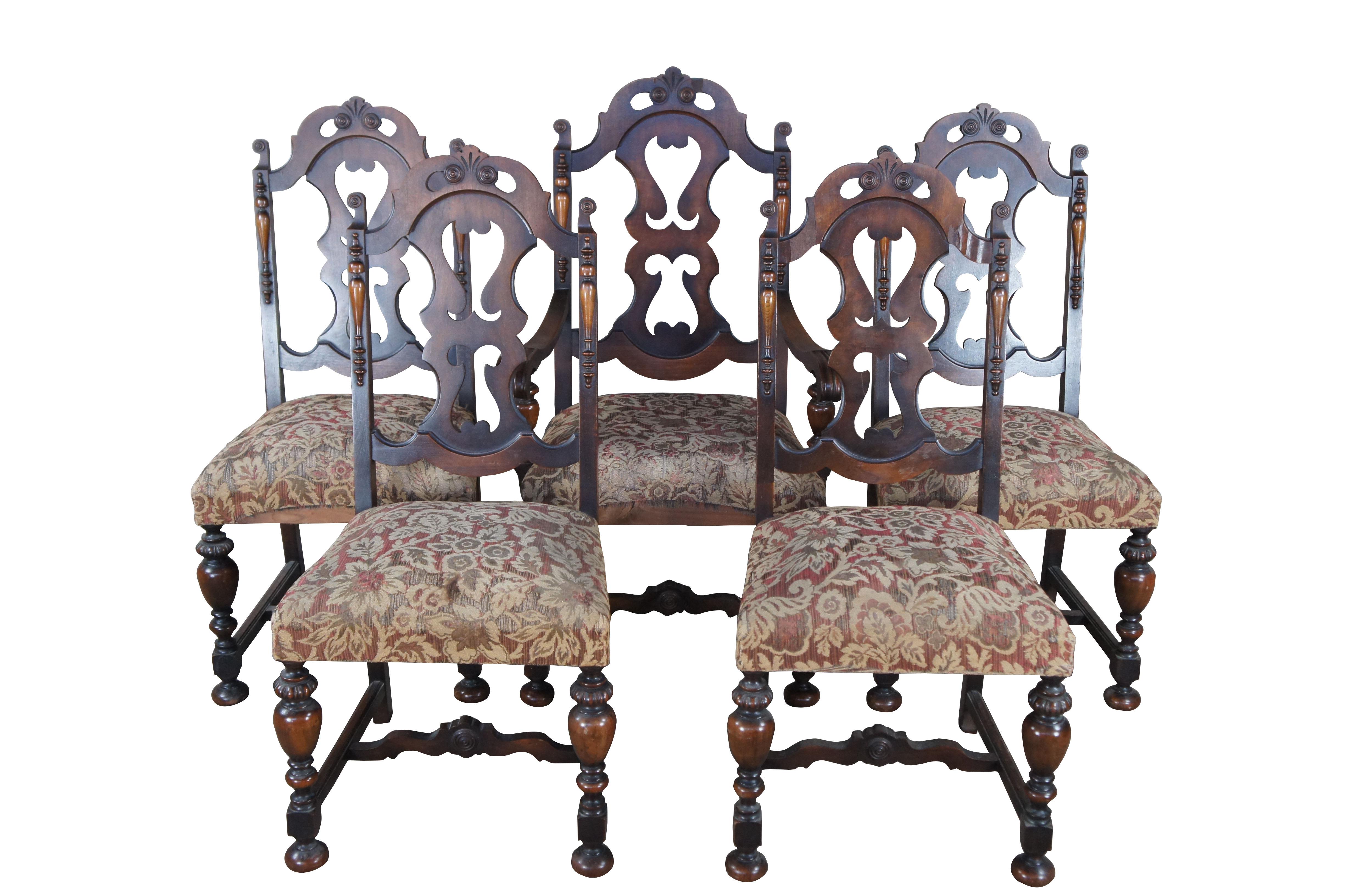 A beautiful set of 5 Rockford Furniture Company Jacobean / Spanish Revival dining chairs, circa 1910-20.  The chairs are made from walnut with pierced back splats flanked by quarter cut spindles.  The chairs are upholstered in a floral pattern and