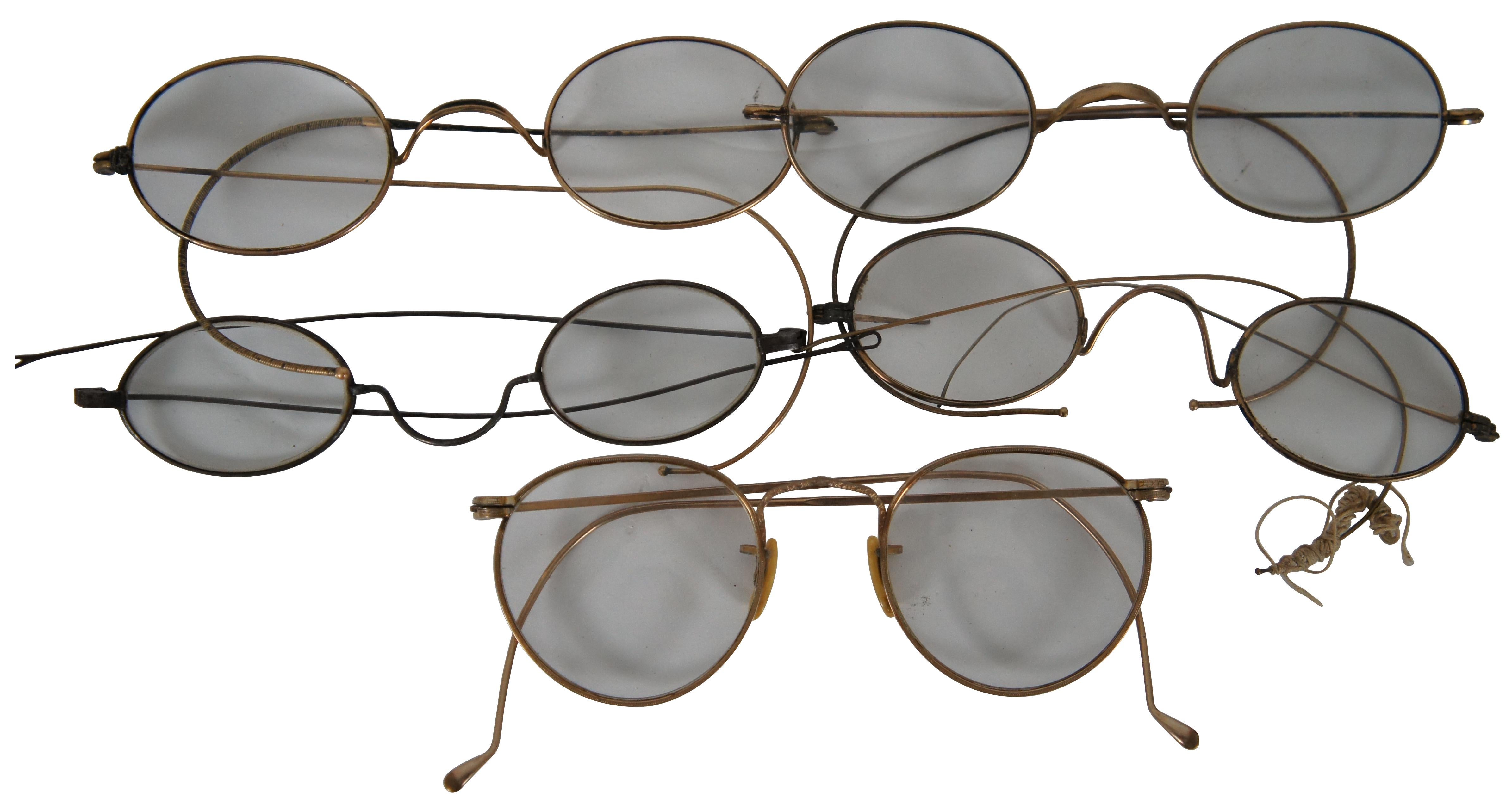 Lot of five antique wire frame eye glasses / spectacles of various lens strengths including one silver tone, four rolled gold / GF. Includes one suede leather slip case and one black leather flip front case.