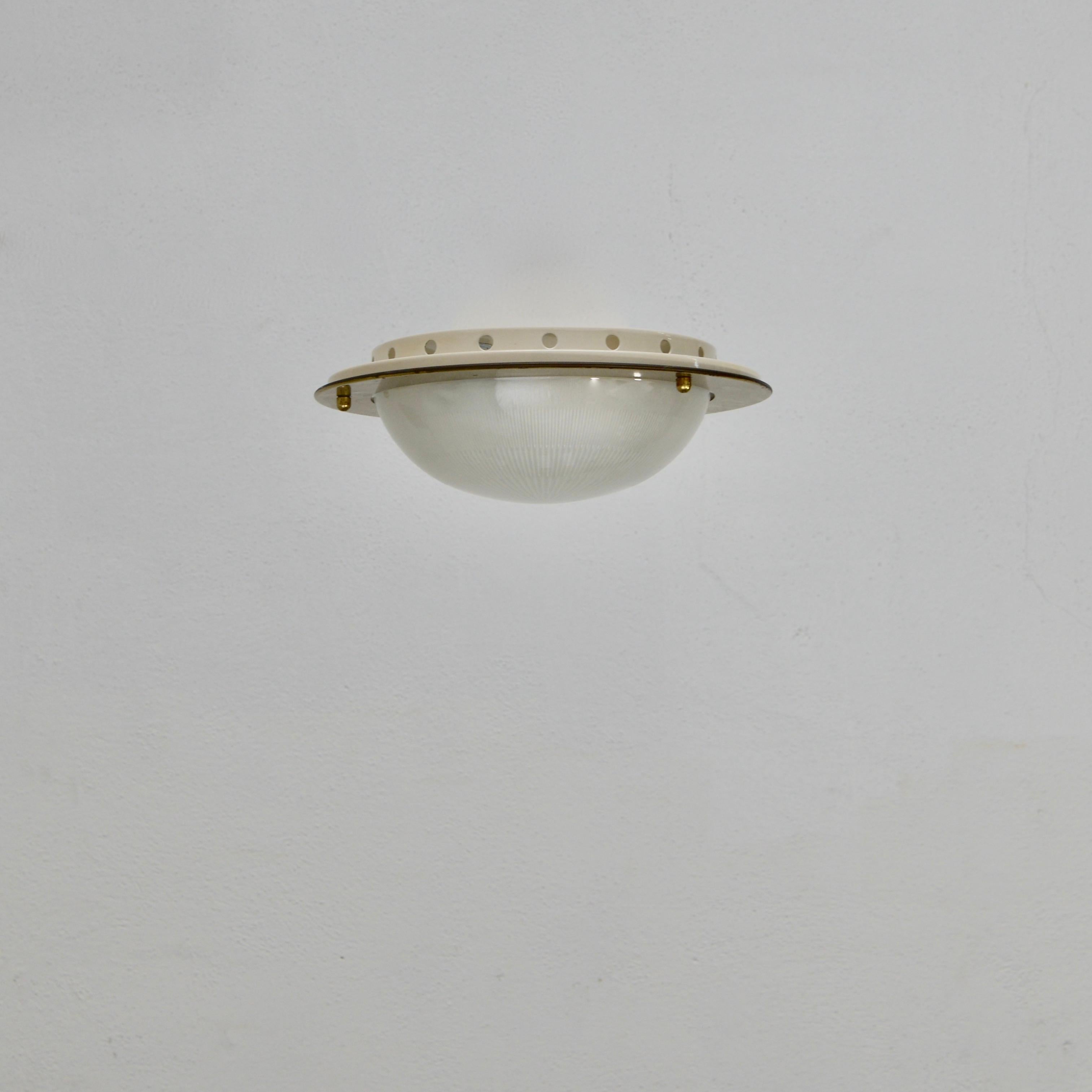 Naturally aged flush mount fixtures by Azucena from 1950s, Italy. In brass and holophane glass details. The light is wired with two E26 medium based sockets and wired for use in the US. Light bulbs included with order. 
Measurements:
Diameter