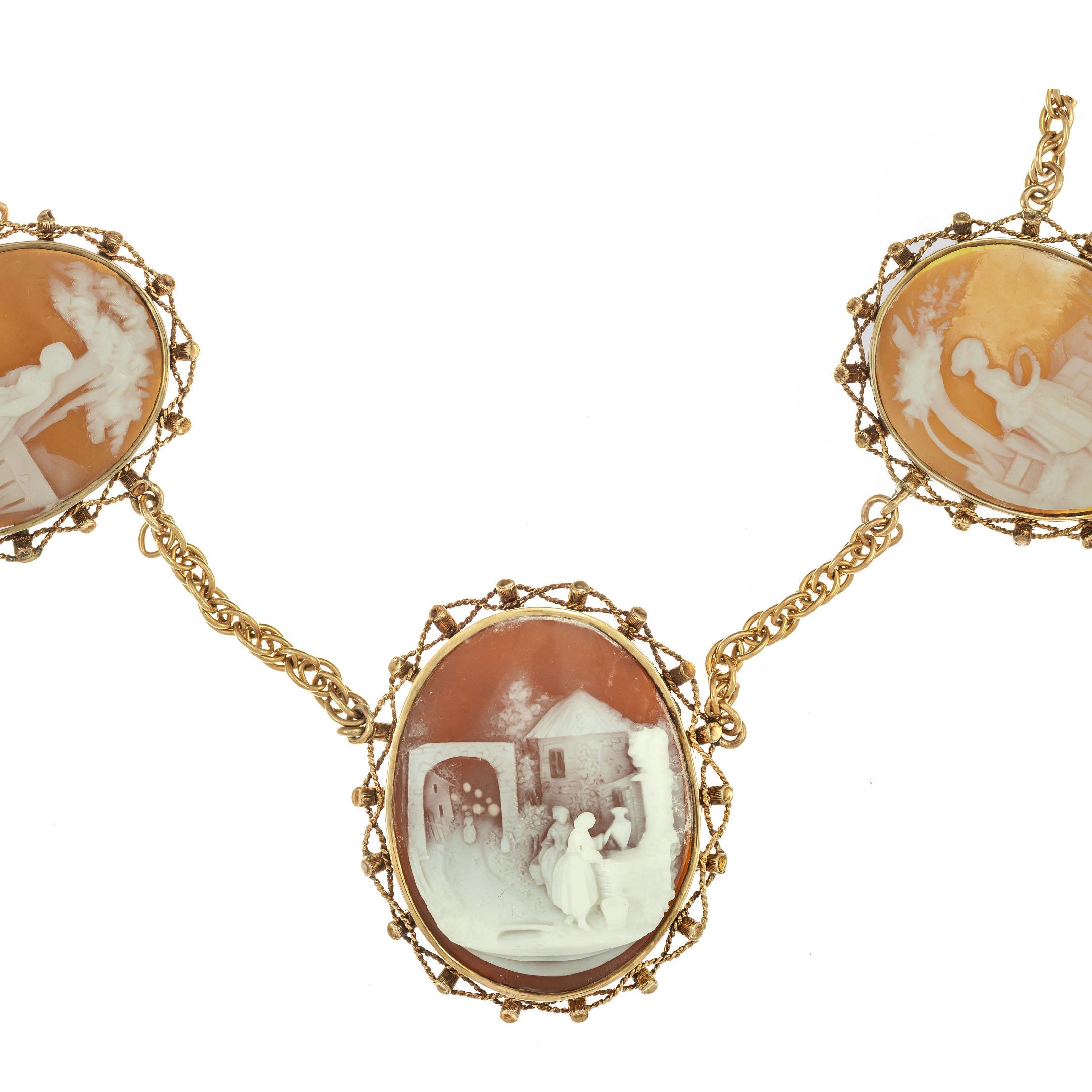 14k yellow gold graduated 5 Cameo necklace. The center Cameo and the 2 end Cameo's are from shells with a darker background color. Twisted wire frame borders around each cameo. 20 inch rope style chain. 

5 hand carved shell Cameo's.  34 x 26mm. (2)