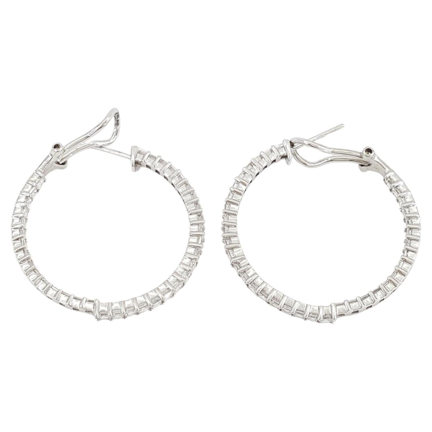 These exquisite round hoop earrings, marked 'ODELIA 585' on the inside, showcase the epitome of luxury and craftsmanship. Each earring is adorned with 36 Natural Square Carre Cut Diamonds, totaling 72 for the pair, which collectively weigh
