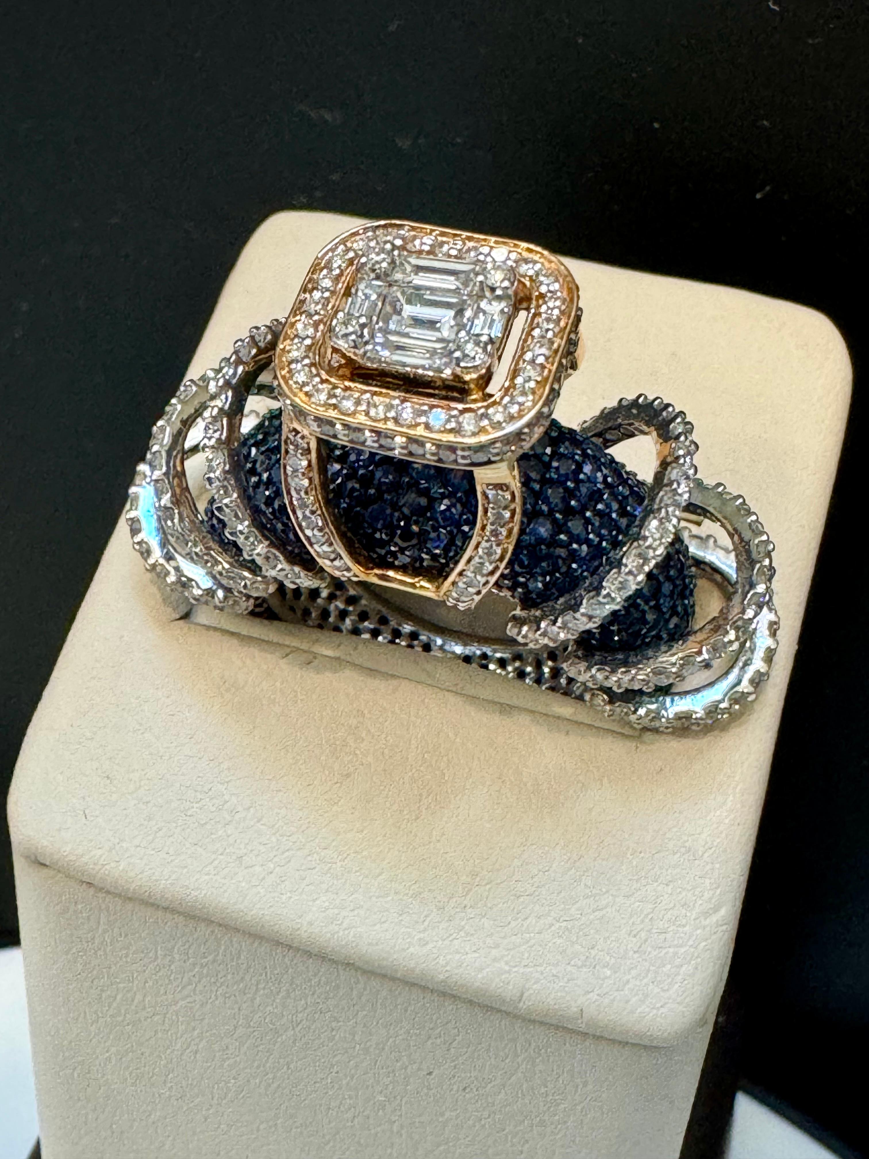Approximately 5 Ct Blue Sapphire & 2 Ct Diamond Cocktail Ring in 18 Karat White Gold Estate
Band is made out of Blue Sapphires.
Round Brilliant cut diamond are forming the Swirl over the blue Sapphire
Total Diamond Weight of brilliant Round cut
