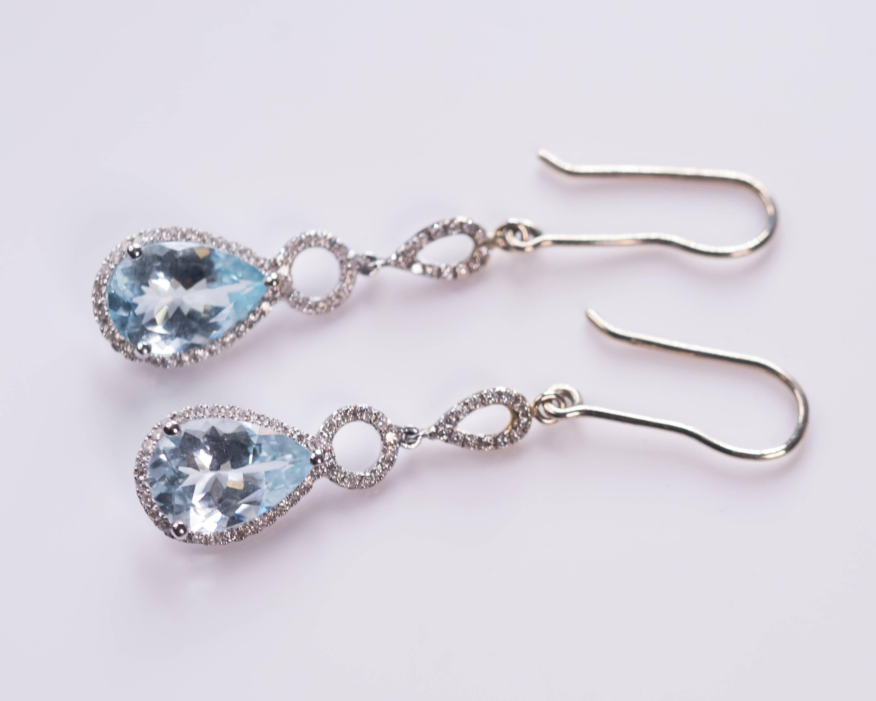 18 Karat White Gold, Blue Topaz and Diamond Drop Earrings - made in house! 

Features 5.0 carats total weight Blue Topaz, .40 carats total weight of Round Brilliant Diamonds and 18 Karat White Gold. Each Pear shaped Light Blue Topaz is surrounded by