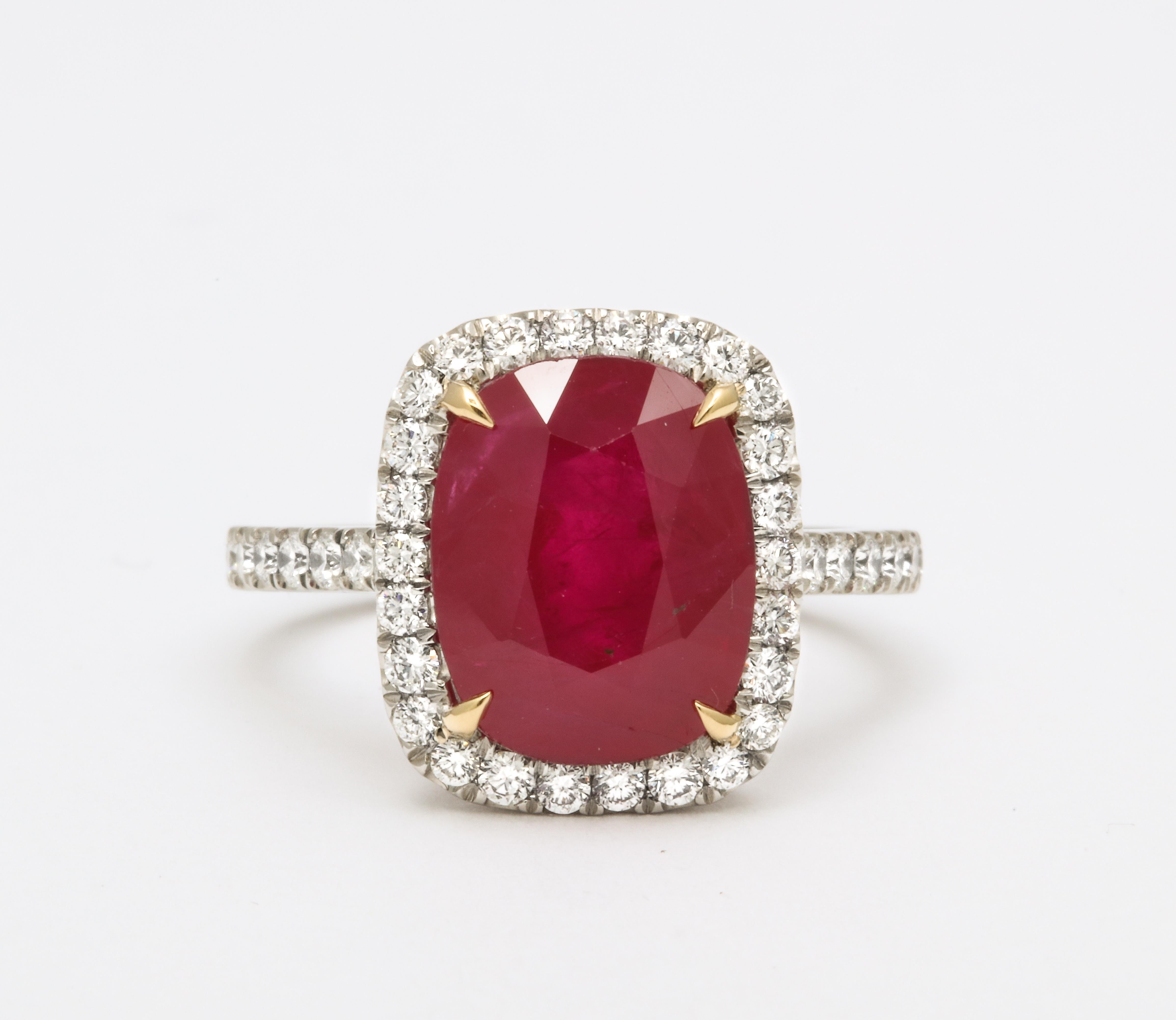 A fine Ruby set in a wearable custom made diamond mounting. 

5.77 carat Cushion cut “Intense Red” Burma Ruby set in a custom made diamond mounting. 

.78 carats of white round brilliant cut diamonds set in platinum. 

Currently a size 6.5, this