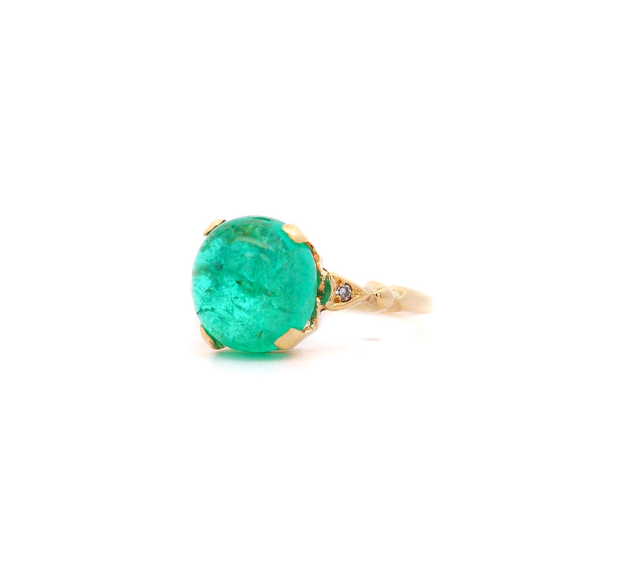 Colombian Emerald and Diamond Ring in 14K Yellow Gold. 

This multi-stone ring features a vibrantly saturated 5-carat Colombian emerald with an attractive cabochon cut. It is paired with 2 round-cut white diamonds and vintage filigree-style