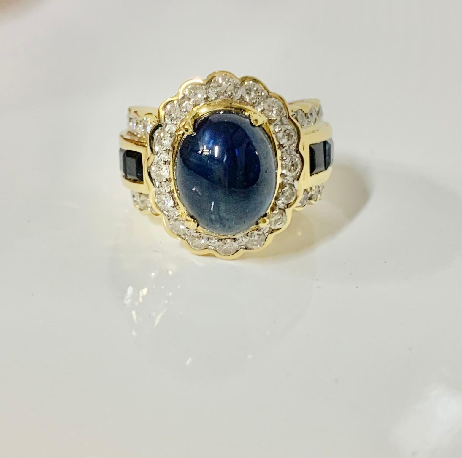 5 Carat Cabochon Sapphire and Diamond Ring 

Stones: Cabochon Sapphire and Square Sapphire  
Stone Shape: Step Cut
Stone Carat: 5 Carat 
Side Stones: Diamonds 
Stone Shape: Round Diamonds
Stone Weight: 0.90 Carat 
Total Ring Weight: 16.1 Grams