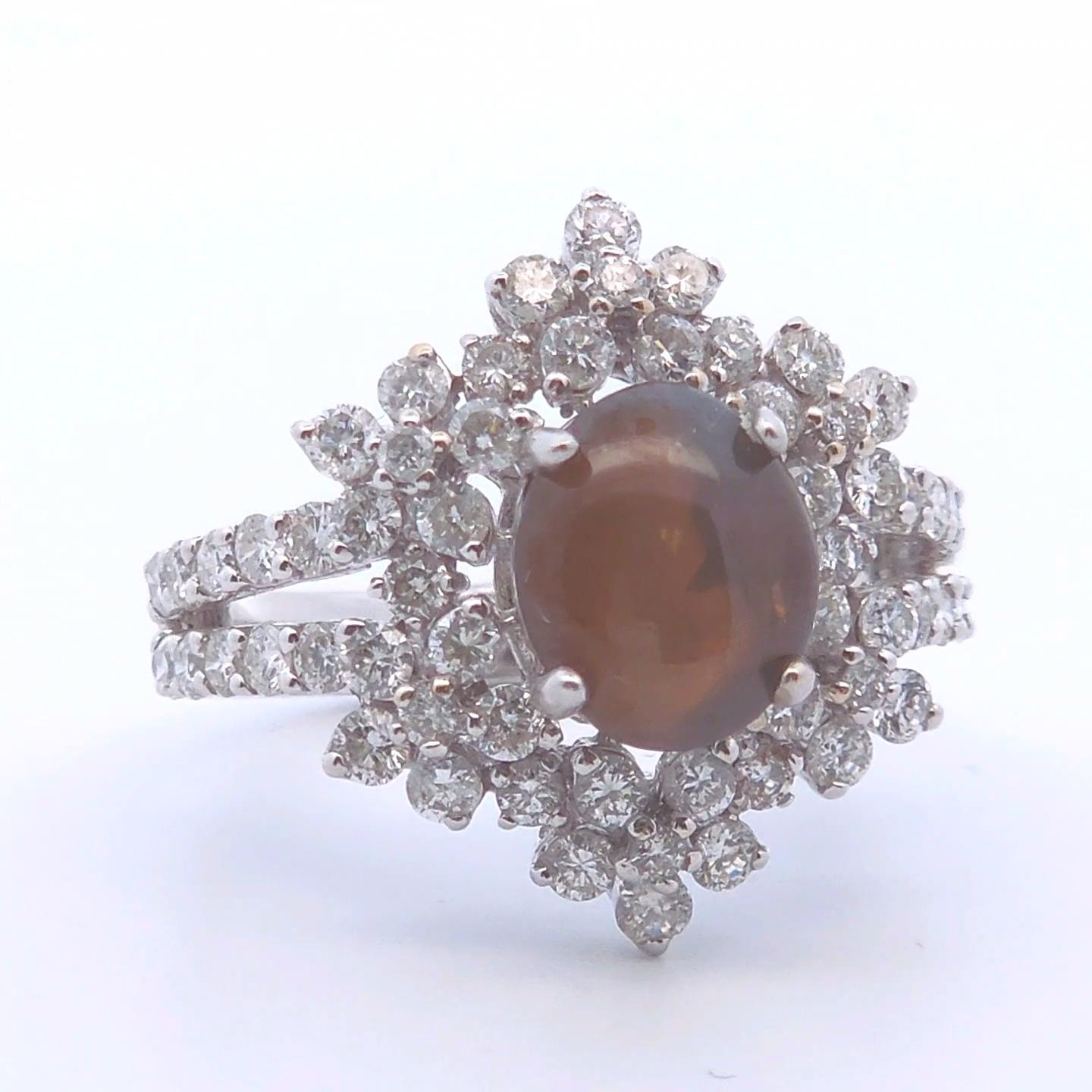 Elevate your collection with this striking 5 Carat Chrysoberyl Cat’s Eye Ring, beautifully set in rich 18k white gold. Known for its rare chatoyancy, this captivating gemstone displays a sharp, luminous line across its surface, resembling a cat’s
