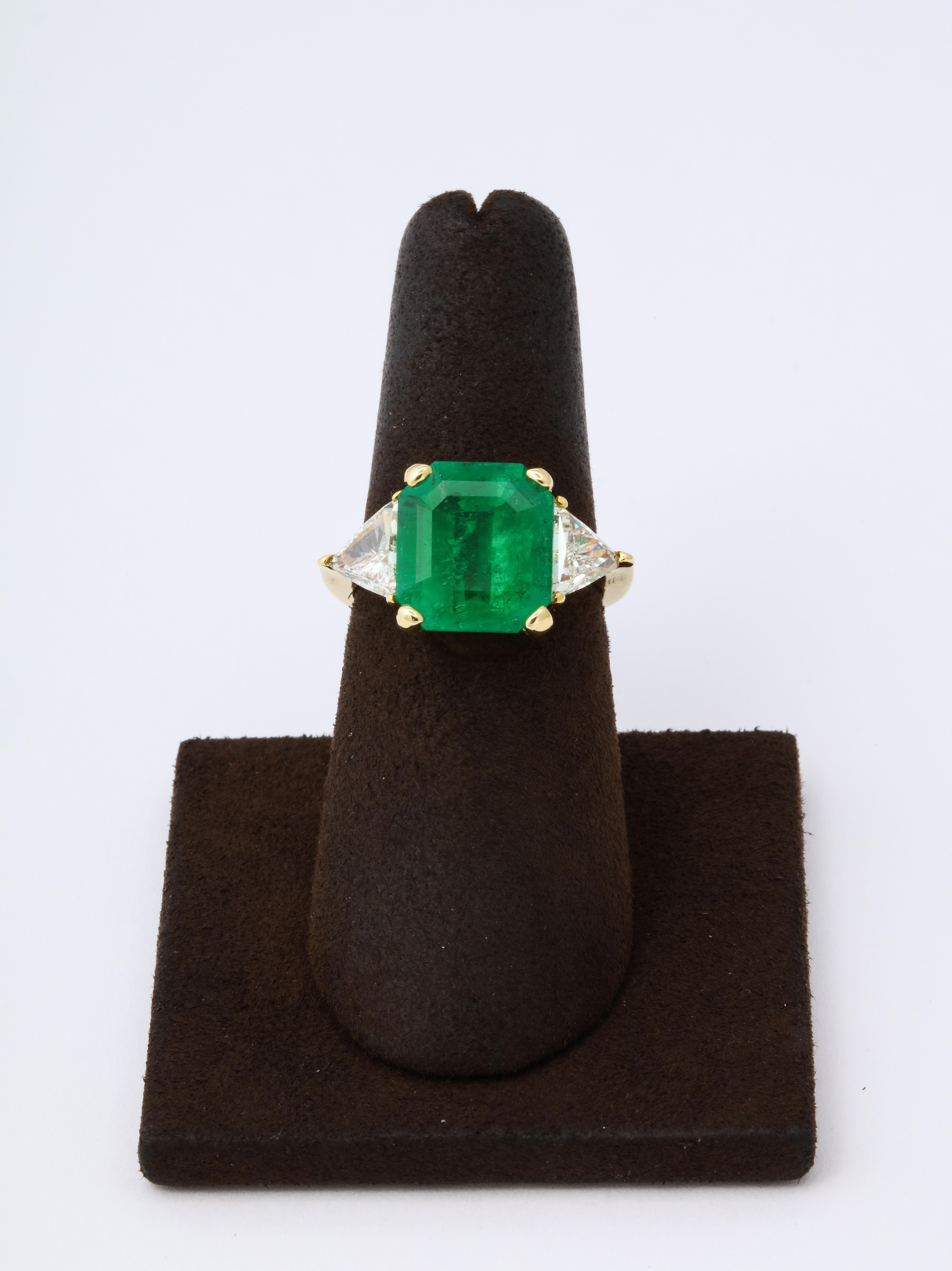 
Pictures do not do this beauty justice!!

A beautiful 5 carat minor Colombian Emerald certified by AGL.

Set with 2.22 carats of diamond trillions in 18k yellow gold.

Currently a 6.5, this ring can easily be sized. 

Part of an Estate collection,