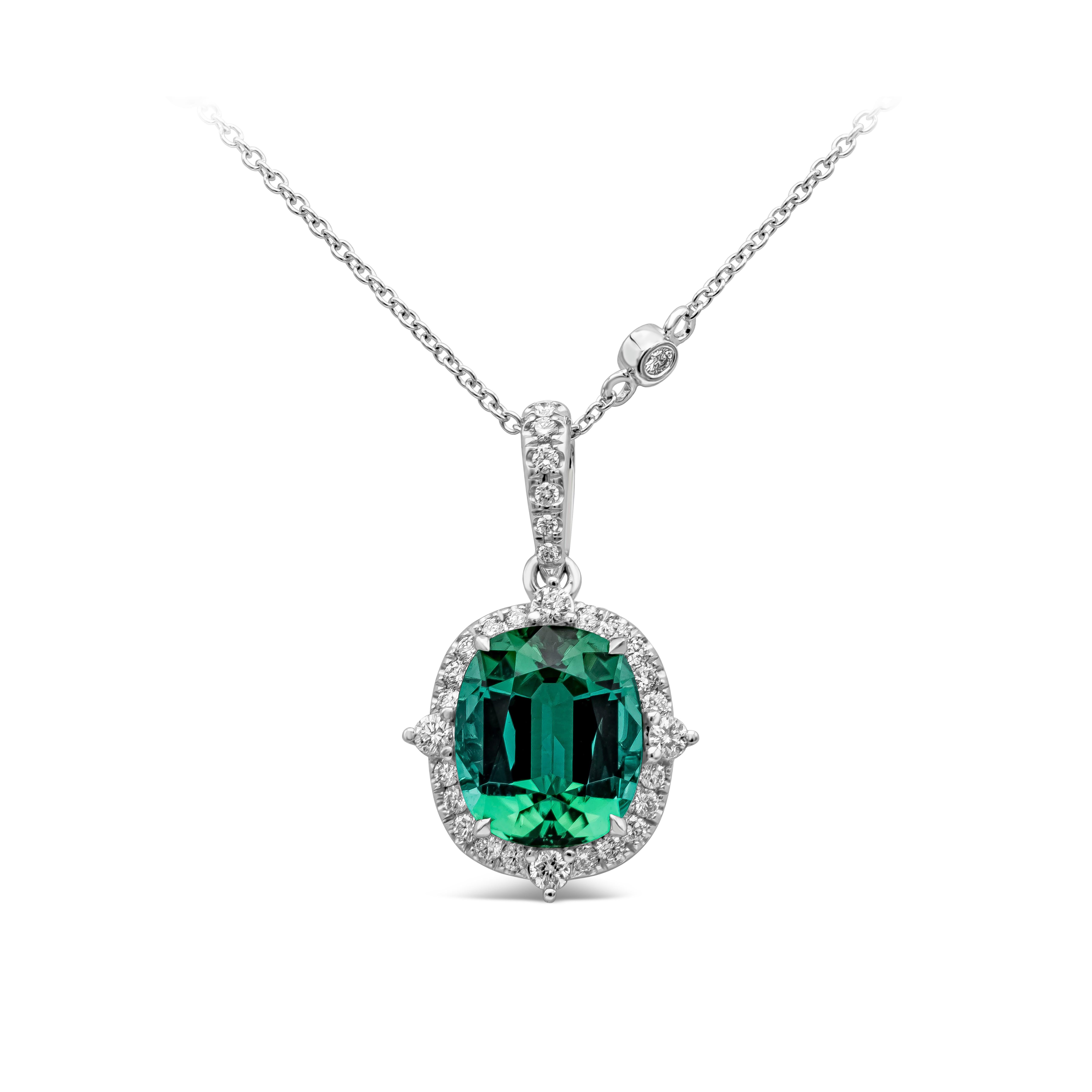 A fashionable pendant necklace showcasing a cushion cut blue green tourmaline weighing 5 carat. Center stone is accented with bright round diamonds weighing 0.95 carats total, F/G color and VS clarity. Chain has 0.52 carats total brilliant round