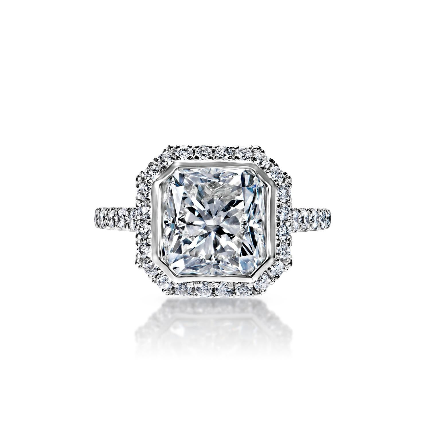 
Center Diamond:

Carat Weight: 4.07 Carats
Color : G
Clarity: VS2
Style: Cushion Cut
Feather Filled- Spl Care Req'd

Ring:
Settings: Halo, Bezel, Sidestone
Metal: 18k White Gold
Style: Round Brilliant Cut
Diamonds: 0.91 Carats
Size: Can be adjusted