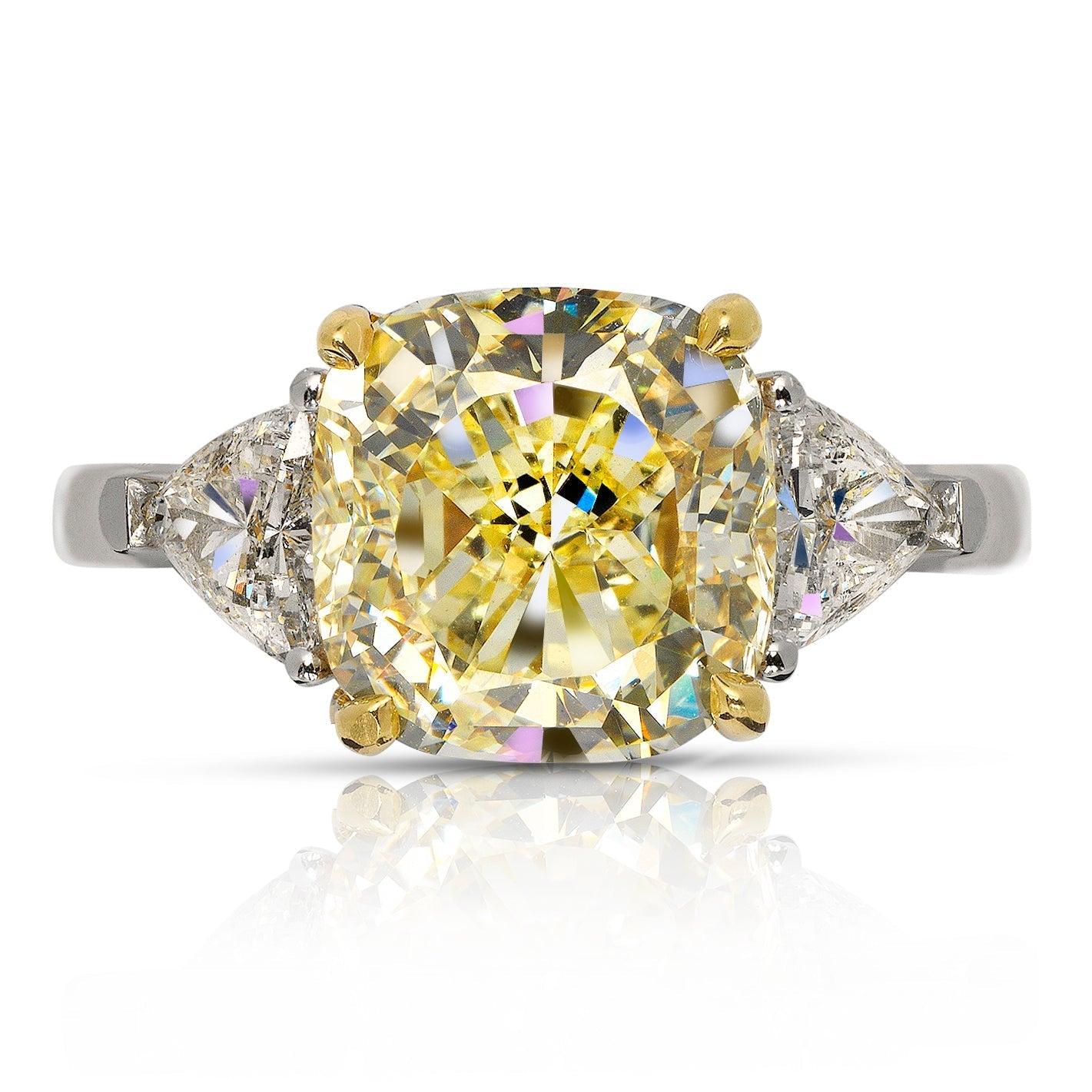 TOHIL- CUSHION CUT THREE STONE TRILLION FANCY YELLOW DIAMOND ENGAGEMENT RING BY MIKE NEKTA
GIA CERTIFIED
Center Diamond:
Carat Weight: 4 Carats
Color: NATURAL FANCY YELLOW 
Clarity: VS1
Style: CUSHION MODIFIED BRILLIANT
Approximate Measurements: 9.2