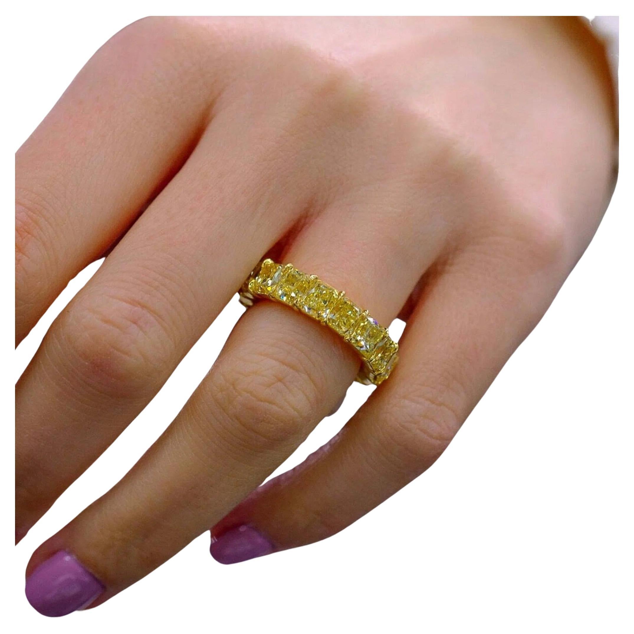 Discover the epitome of luxury with our IGI Certified 18K Yellow Gold Fancy Yellow Cushion Diamond Eternity Band Ring. This breathtaking piece is meticulously crafted from 18-karat yellow gold and showcases a magnificent array of 19 natural, fancy
