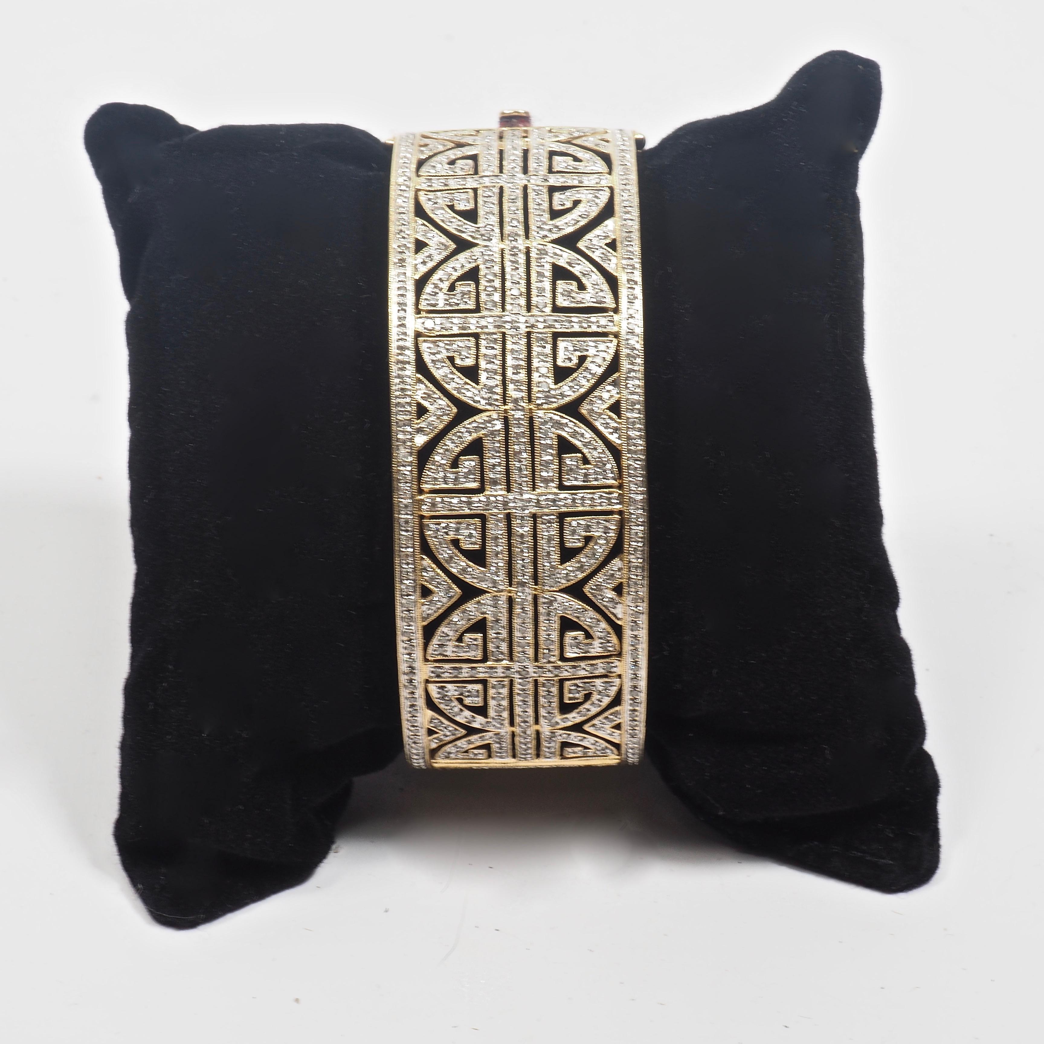 Superb 14 karat yellow gold and diamond fretwork geometric bangle. The bracelet is set with 516 round cut diamonds in an interlocking Chinese emblem pattern symbolising prosperity and good luck. 5 ct. Diamonds rated SI clarity and H-I colour.