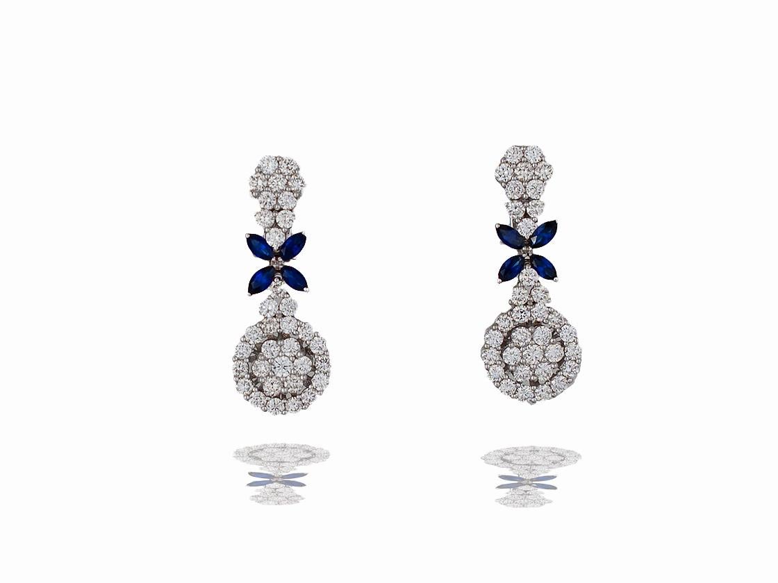 This stunning pair of earrings measure 35 x 14 mm.  This pair of earrings has sixty eight round brilliant diamonds that exhibit a color and clarity of F-G VS-SI.  The diamonds are set in a prong style.  There are four 6 x 3 mm blue sapphire marquise