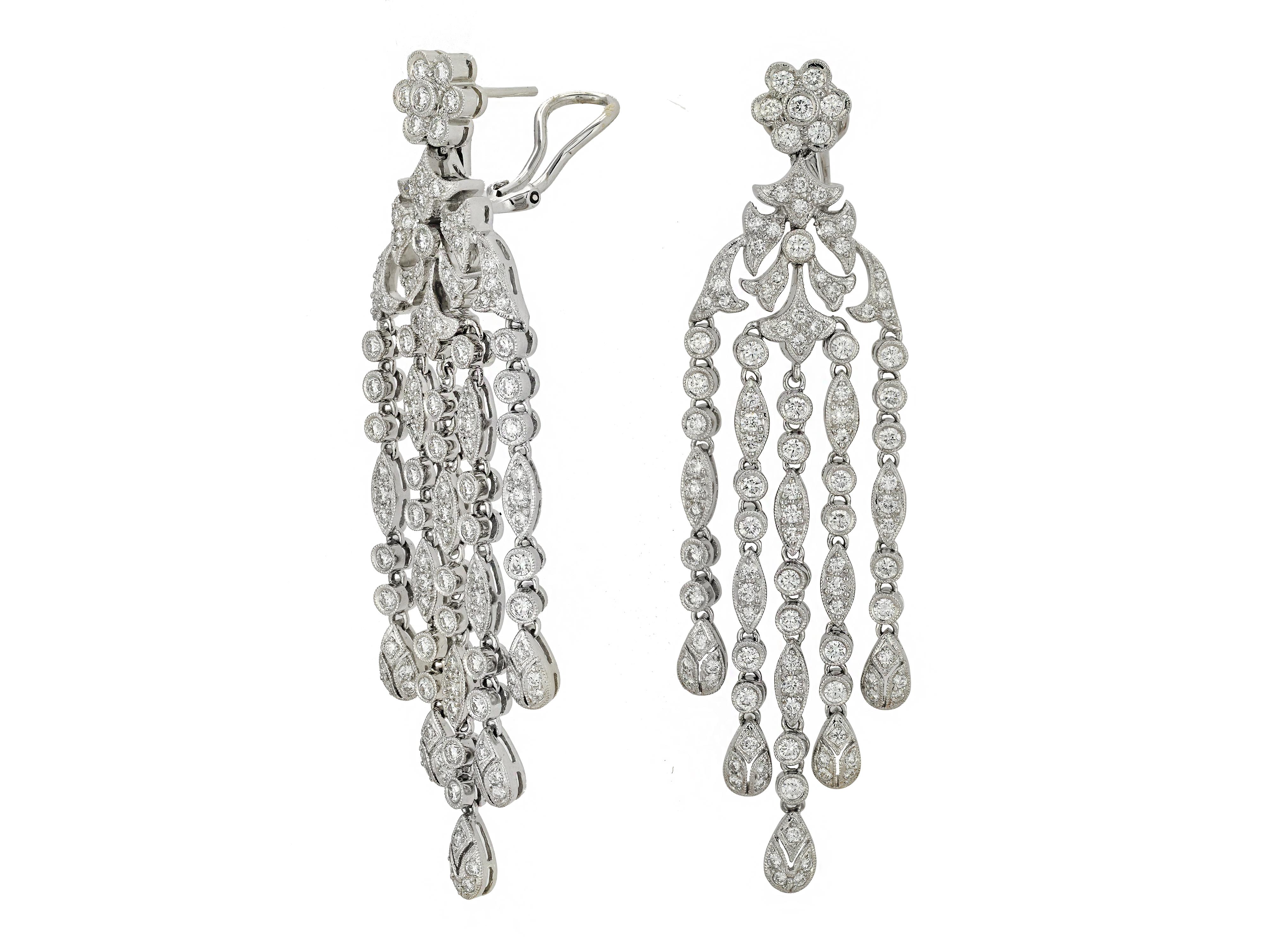 18 Karat White Gold Waterfall Earrings With 218 Prong & Bezel Set Round Diamonds Totaling Approximately 5.00 Carats of VS Clarity & G Color. 5 Articulated Drops Move With The Wearer. Pierced Post With Supportive Omega Clip Back.