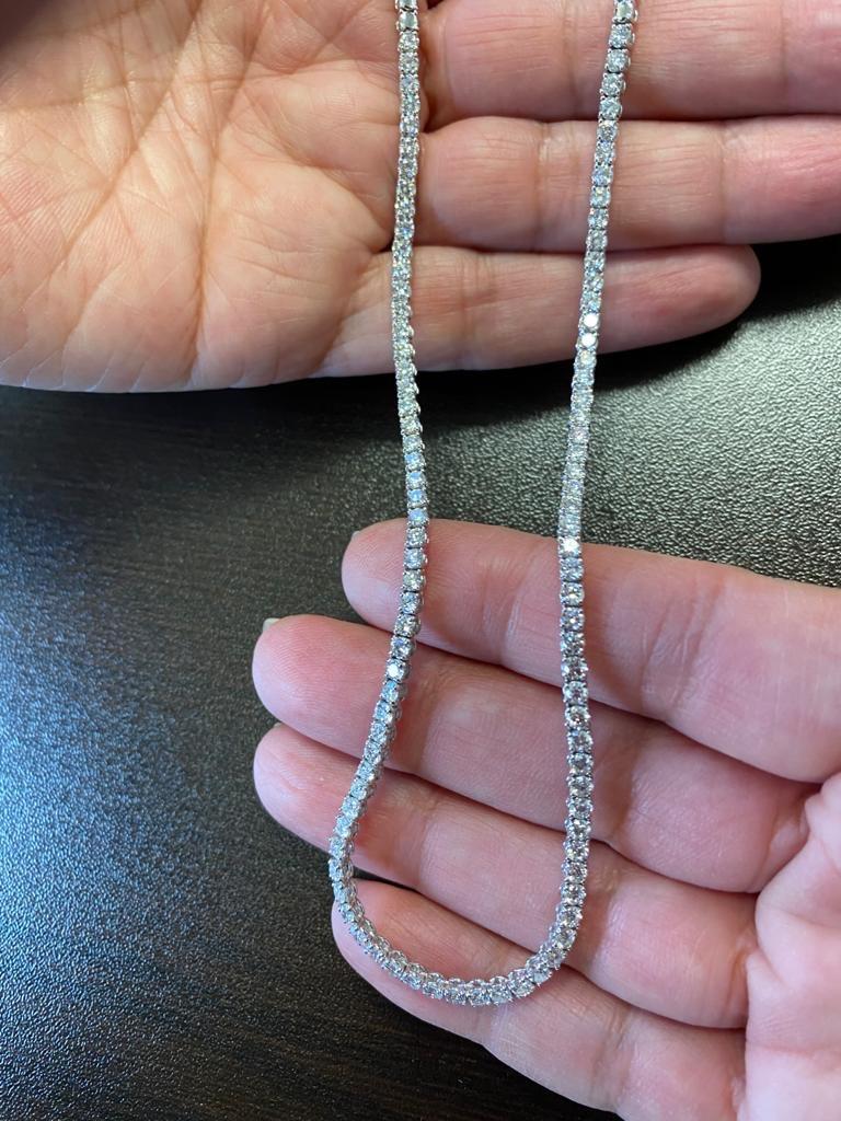 Diamond necklace set halfway in 14K white gold. Each stone weighs 0.05 carats, the diamond weight is 4.90 carats. The color of the stones are G, the clarity is SI1-SI2. The total length of the piece is 17 inches.