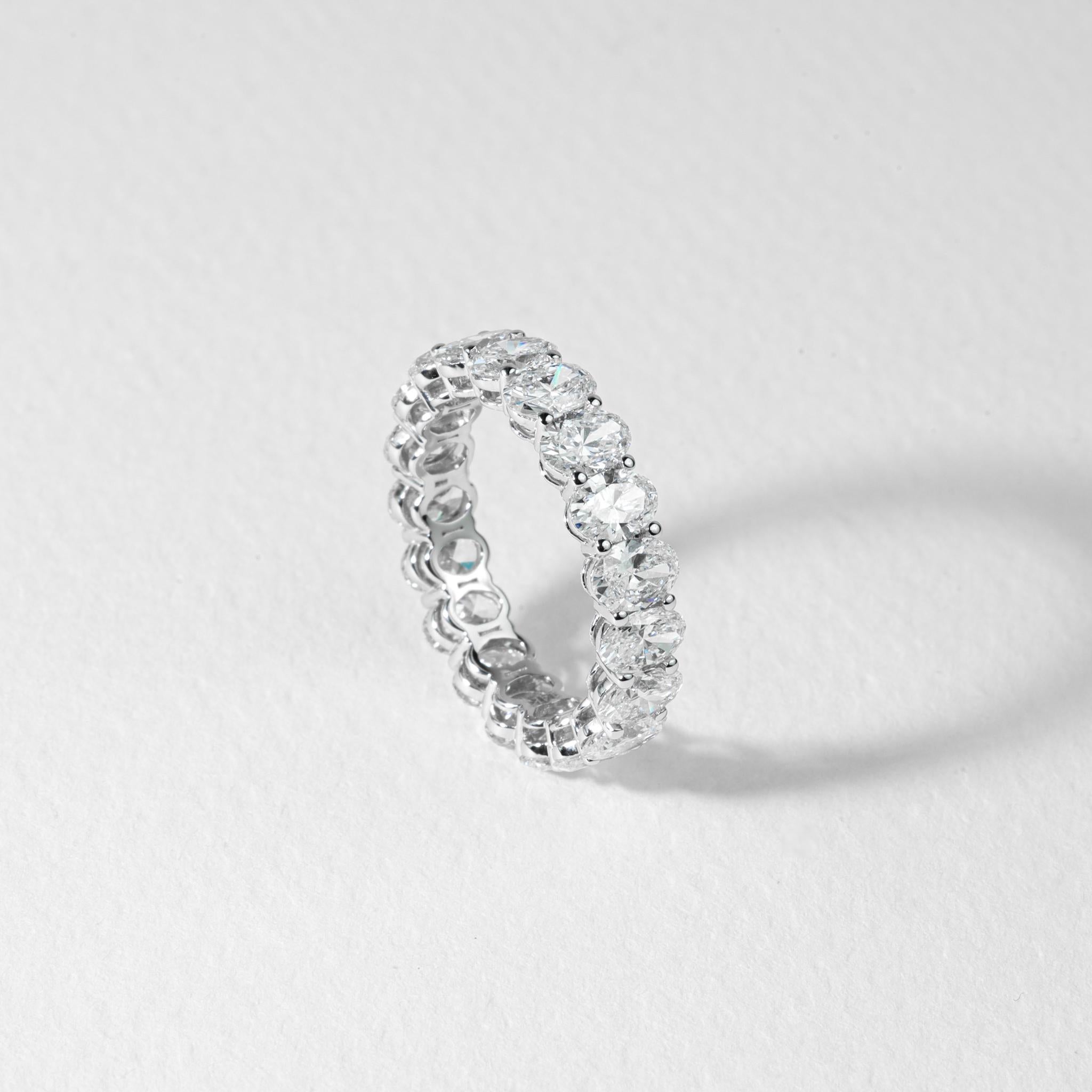 A stunning celebration of eternal elegance, this full eternity band showcases approximately 4.83 carats of natural oval-cut diamonds, each meticulously hand-selected for its F color and VS clarity. A total of 19 luminous stones (stone count and