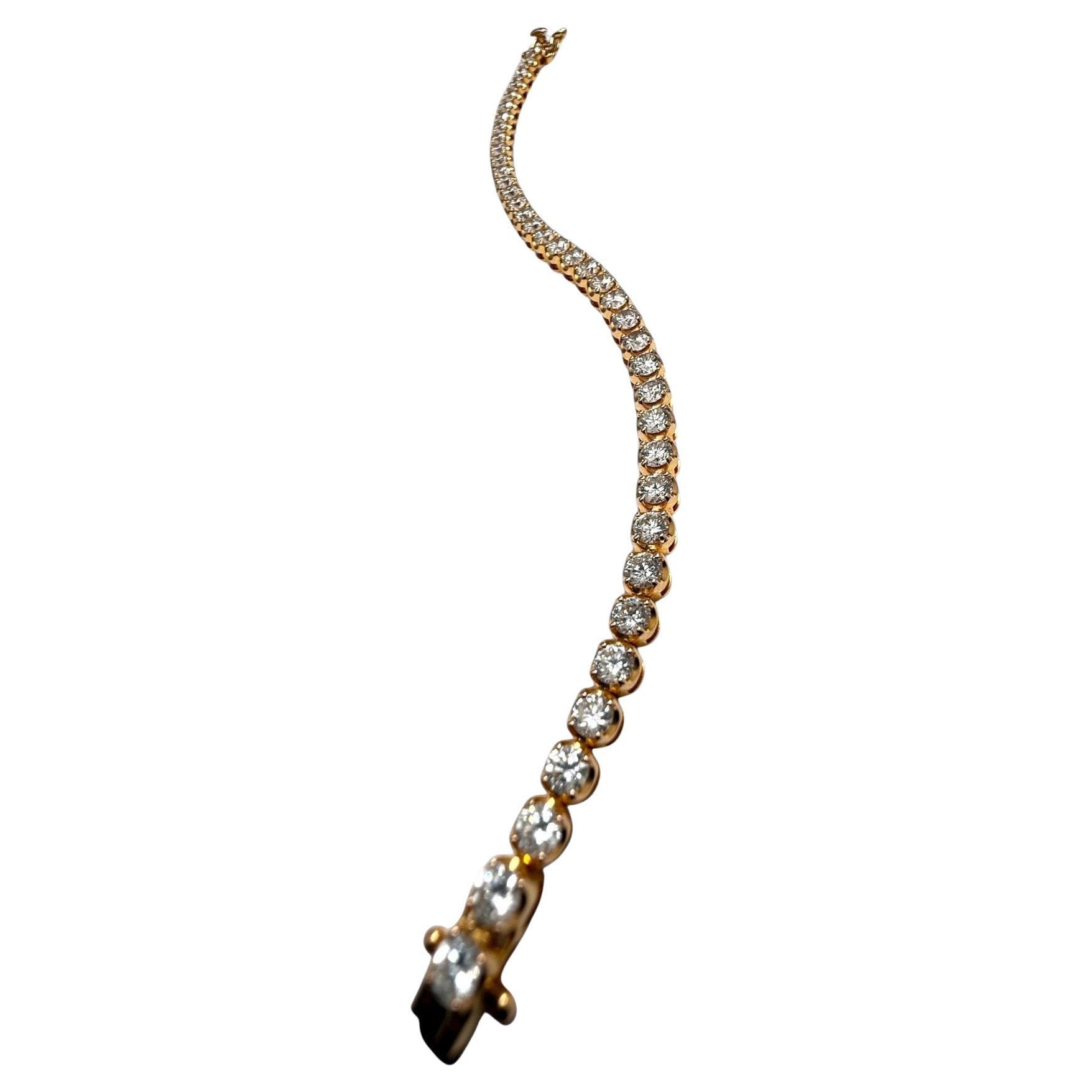 Eleva il tuo polso con questo squisito bracciale tennis con diamanti, un pezzo senza tempo rivisitato nella calda luce dell'oro giallo 18 carati. Questo bracciale è caratterizzato da una linea continua e flessibile di diamanti brillanti di