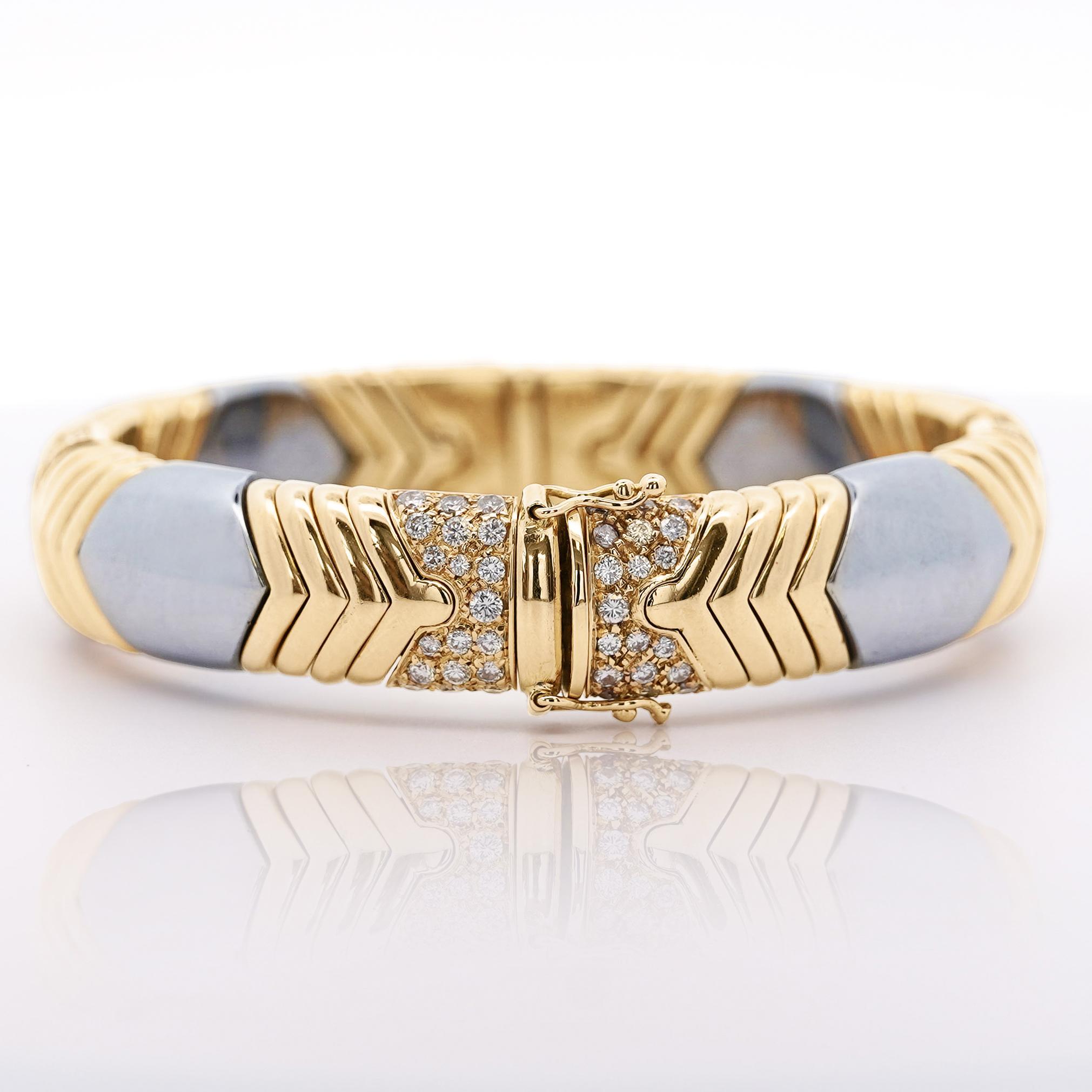 A bold and striking vintage diamond bangle crafted from Italian 18K yellow gold and steel, featuring 5.0ct of round brilliant diamonds in a retro-inspired geometric design.

Details:
Item Type: Bangle Bracelet
Metal: 18K Yellow Gold & Steel
Width: