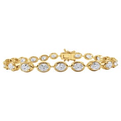Bracelet de tennis en or jaune 14 carats, serti d
un chaton, diamant ovale est-ouest