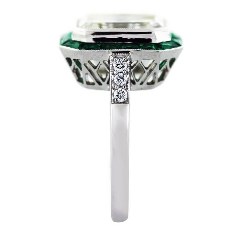 Style: 5 Ct Emerald Cut Diamond and Emerald Art Deco Style Platinum Engagement Ring
Main Diamond: Emerald Cut Diamond
Diamond Carat Weight: 5.02ctw
Diamond Color: K
Diamond Clarity: VS2
Mounting Details: Platinum and Diamond Setting With 1.16ctw of