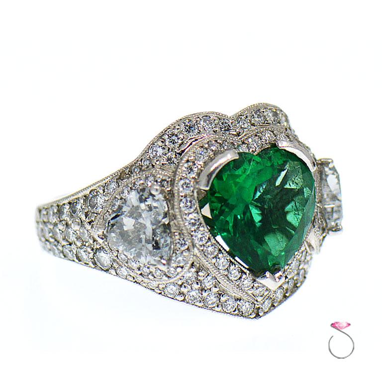 This gorgeous Natural Colombian Emerald & Diamond Pave' ring is just stunning. This ring features an approximately 5.00 carat natural Heart shape Emerald  in the center surrounded by a beautiful 27 diamond halo. The ring is additionally set with 74