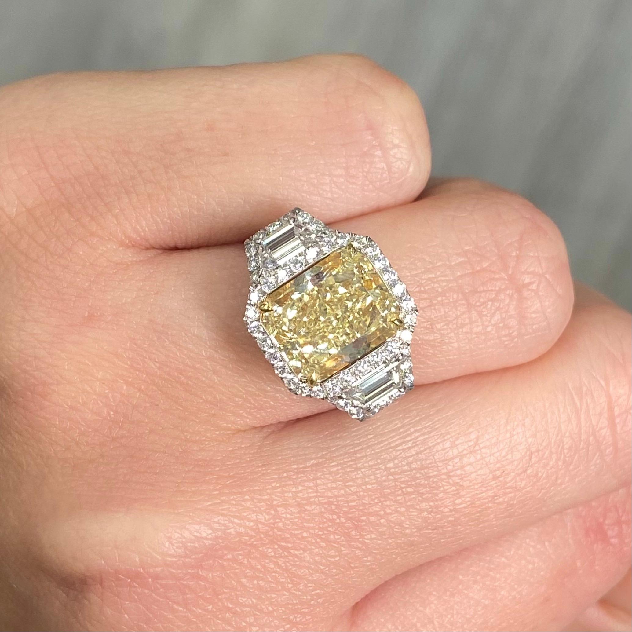 - Huge look with this three stone ring surrounded by halos

5.14 Carat center diamond
Light yellow diamond, Y-Z range
Elongated radiant cut, 1.21:1 ratio
VS2 Clarity 
Set with .64 Carats White Trapezoids H VS1
Total Ring Weight 6.65 Carats
Platinum