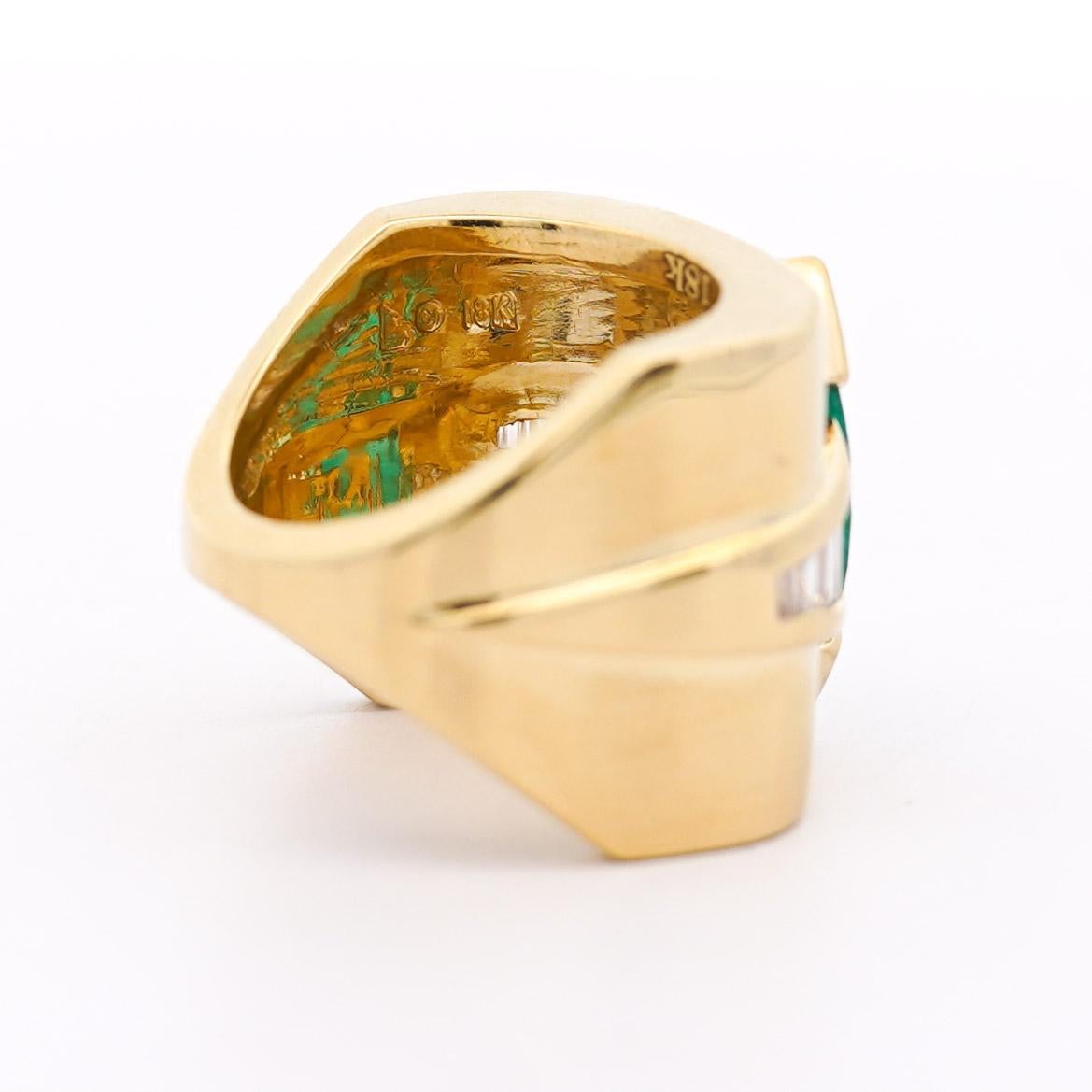 Vintage 5 Carat Natural Marquise Cut Emerald and Baguette Diamond  Eye Motif 18K Yellow Gold Unisex Statement Ring. The band bears a square, wide frame with rounded ends to hug and cover the finger. Half bezel set emerald and graduated channel set