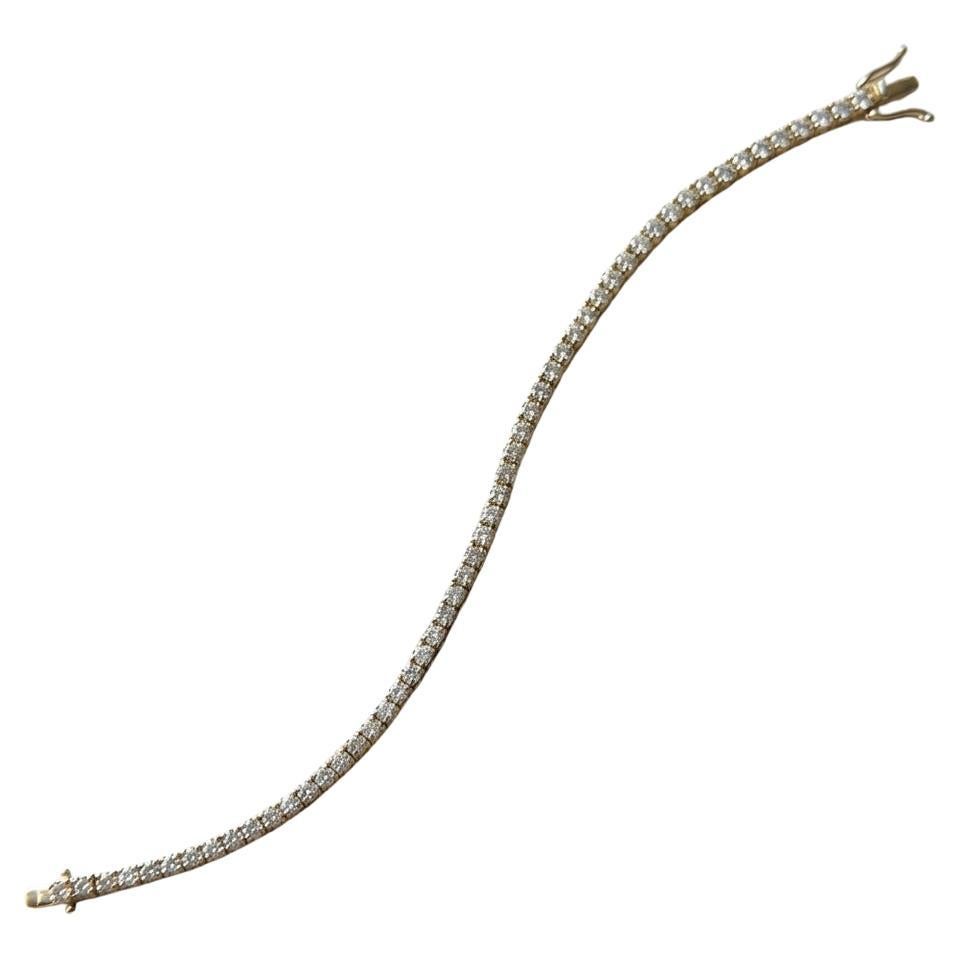 A substantial tennis bracelet crafted in 14k yellow gold, containing approximately 5 carats of natural round brilliant-cut diamonds. 

The bracelet weighs about 8.1 grams and features secure prong settings, ensuring durability and comfort for