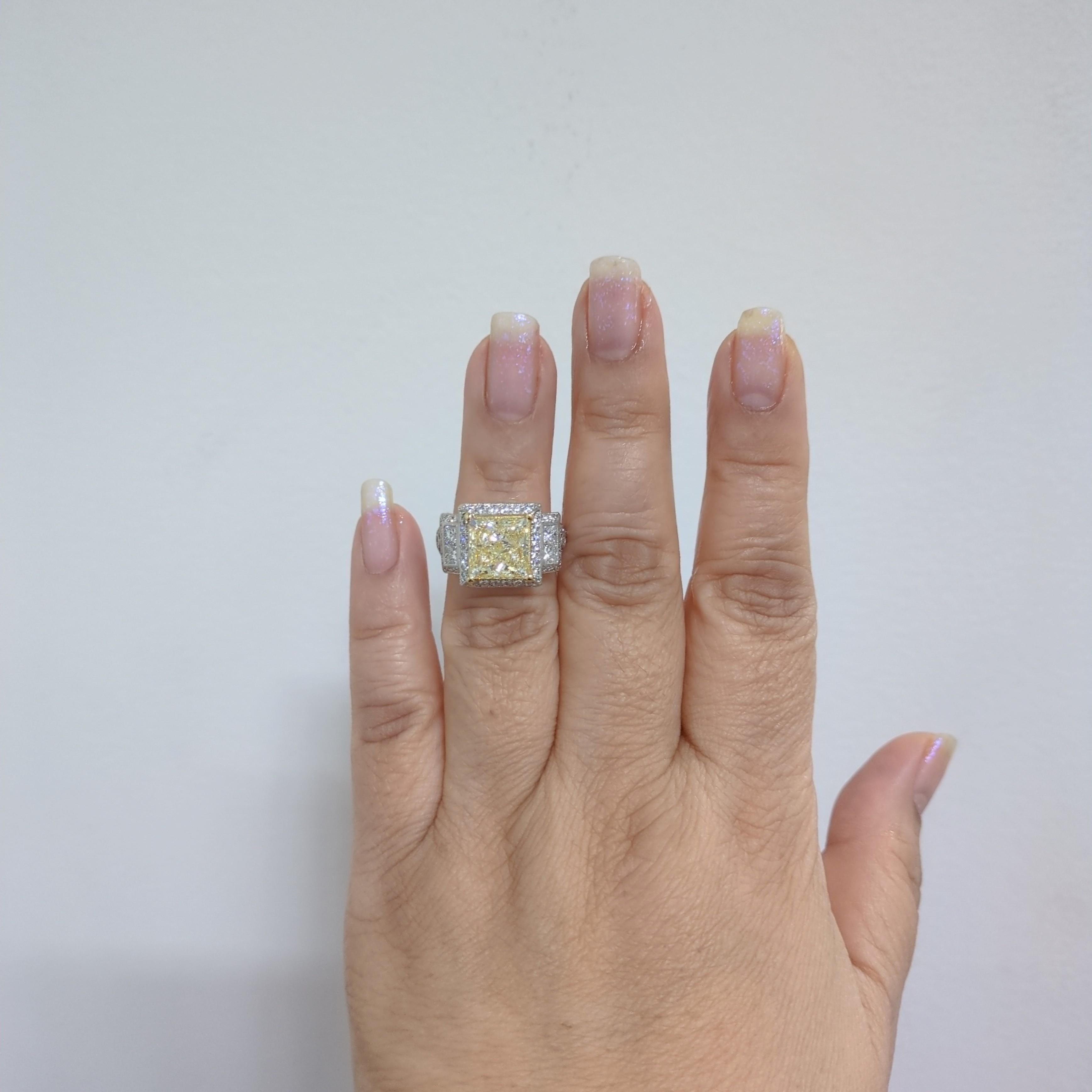 Gorgeous 5.05 ct. yellow diamond princess cut with good quality white diamond rounds and squares.  Handmade in 14k white and yellow gold.  Ring size 6.5+.