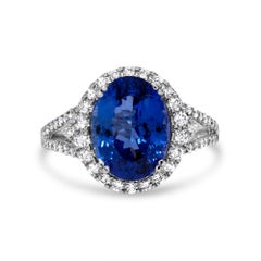 Bague mode audacieuse et élégante en or blanc 14 carats avec tanzanite bleue ovale de 5 carats et diamants