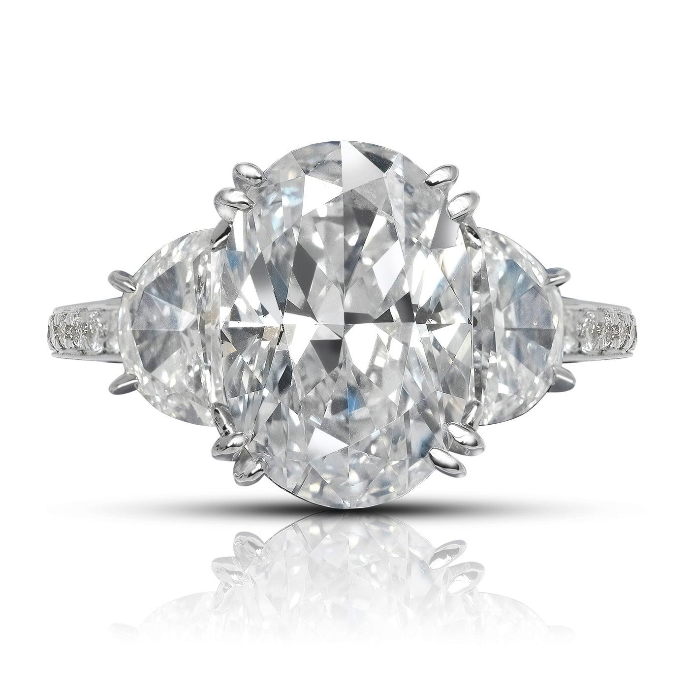 EMMA DIAMOND ENGAGEMENT PLATINUM RING BY MIKE NEKTA
GIA CERTIFIED

Center Diamond:
Carat Weight: 4 Carats
Color: E*
Clarity: VVS1
Style:  OVAL BRILLIANT
Measurements: 12.2 x 8.4 x 5.3 mm
*Treated Color
Ring:

Metal: PLATINIUM
Style: Three Stone Half