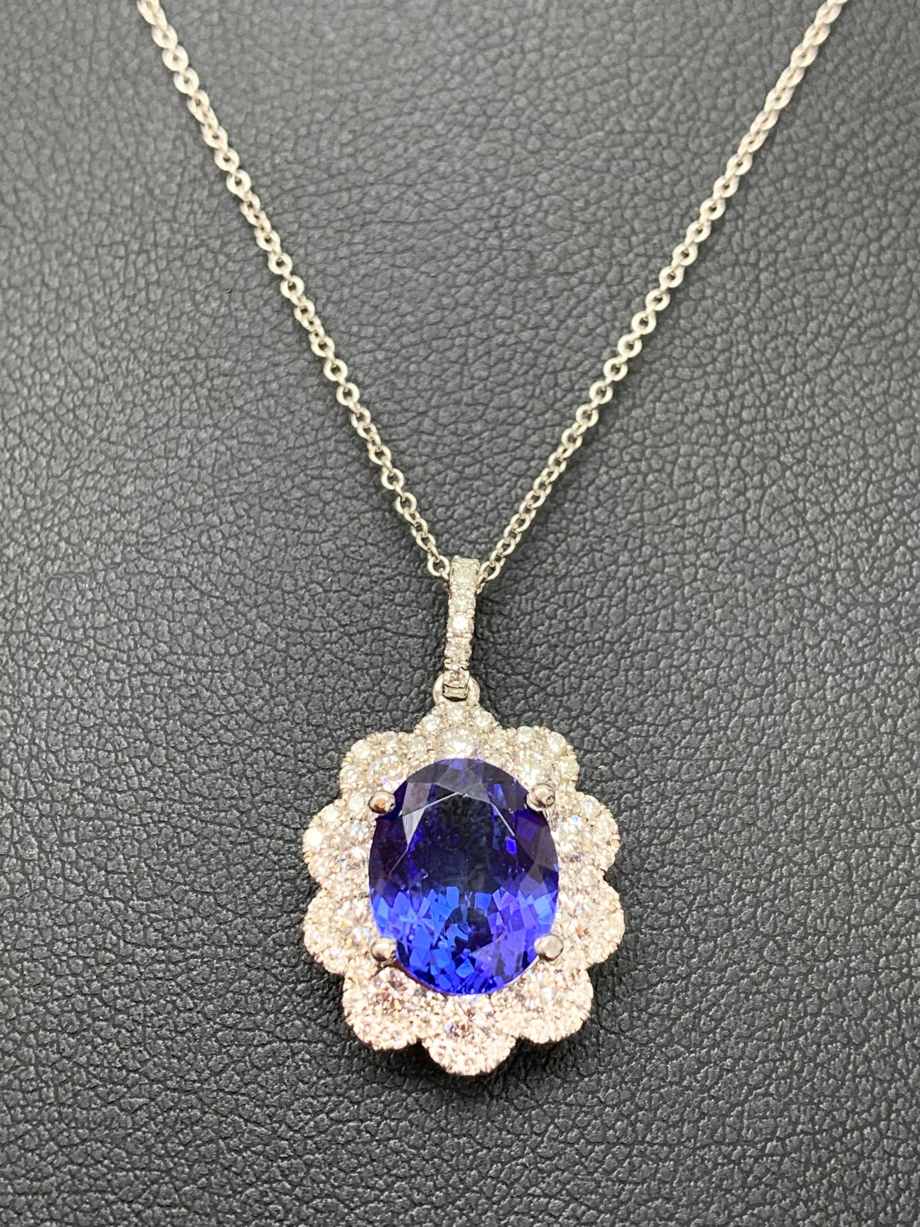 A simple floral motif pendant necklace showcasing a vibrant 5-carat oval cut tanzanite, surrounded by 
1.13 carats of 74 accent round diamonds. Made in 18 karats white gold.

Style available in different price ranges. Prices are based on your