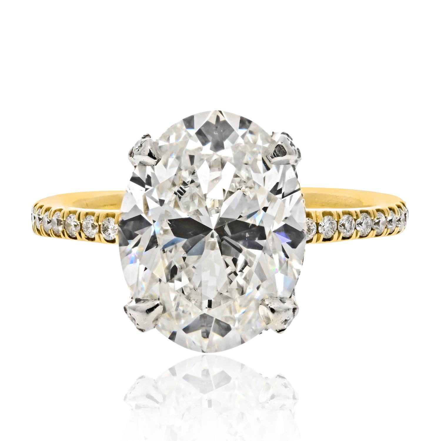 Classic diamond engagement ring with a 5 carat Oval Cut diamond. It is GIA-certified J color, VS1 clarity. We love the pave diamond setting with the hidden halo and diamonds on the prongs. When she puts this ring on all she will see is this gorgeous