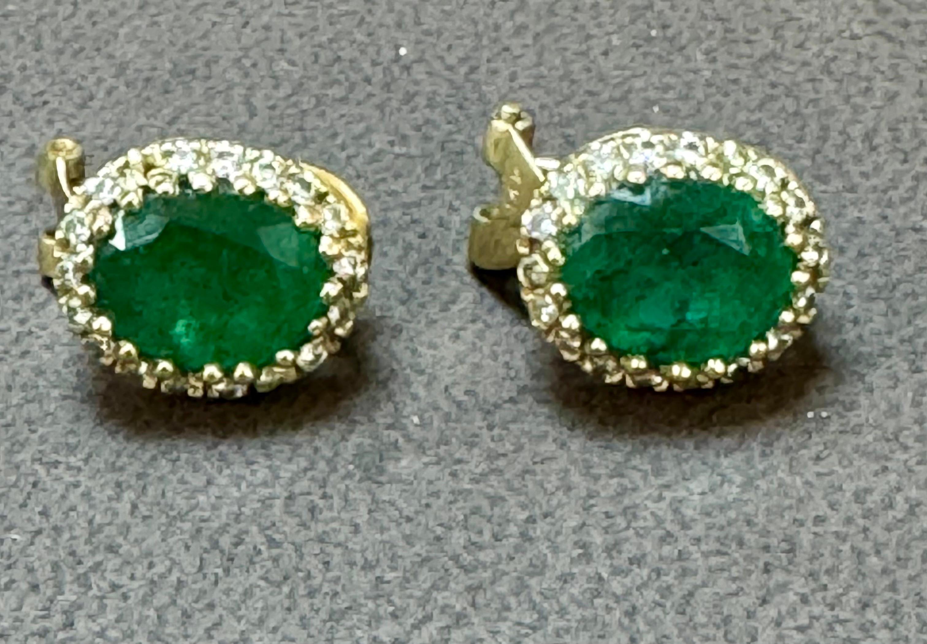 These stunning post back earrings with French clip feature a natural oval-shaped emerald weighing total approximately 5 carats, accompanied by brilliant round cut diamonds. Each emerald is 2.5 ct . The emeralds are of very fine quality with a