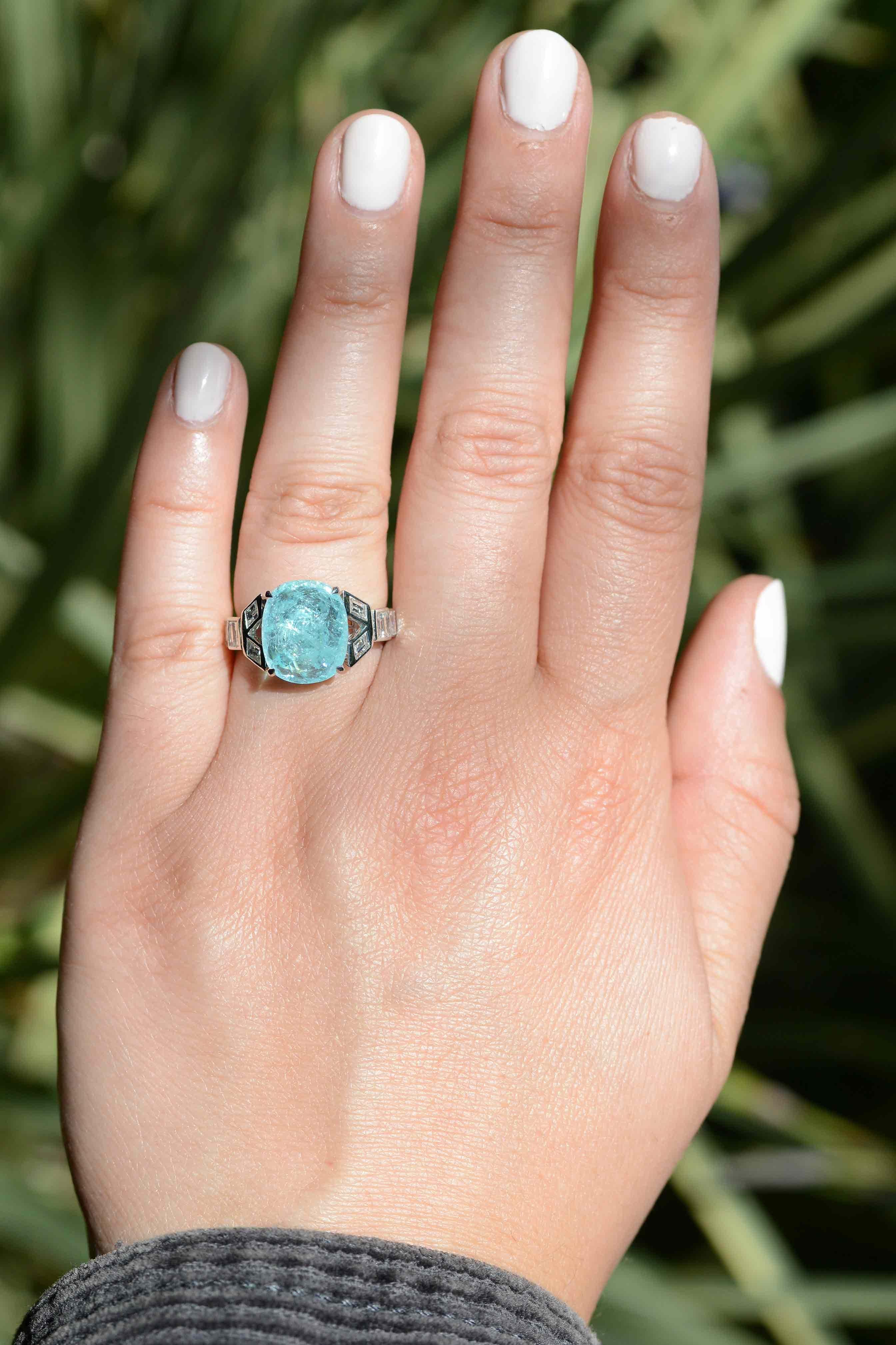 The Pedrina 5 carat Paraiba tourmaline engagement ring is absolutely incredible. A rare and prestigious sugarloaf cabochon cut gemstone that is highly prized for its unique, distinctive color. This one particularly displays an enthralling icy blue