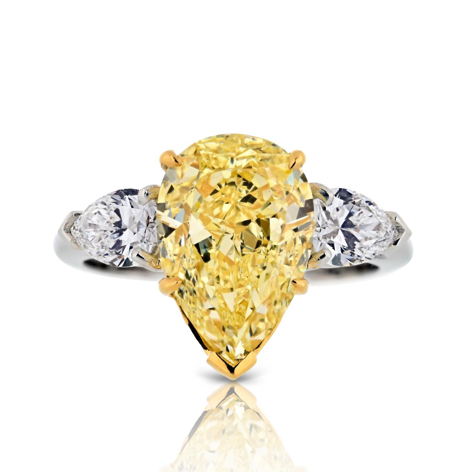 Elevate your love story with the enchanting beauty of this 5 Carat Pear Shape Fancy Yellow Three Stone Diamond Engagement Ring, a masterpiece designed to captivate hearts and celebrate enduring love.

At the heart of this ring is a remarkable GIA