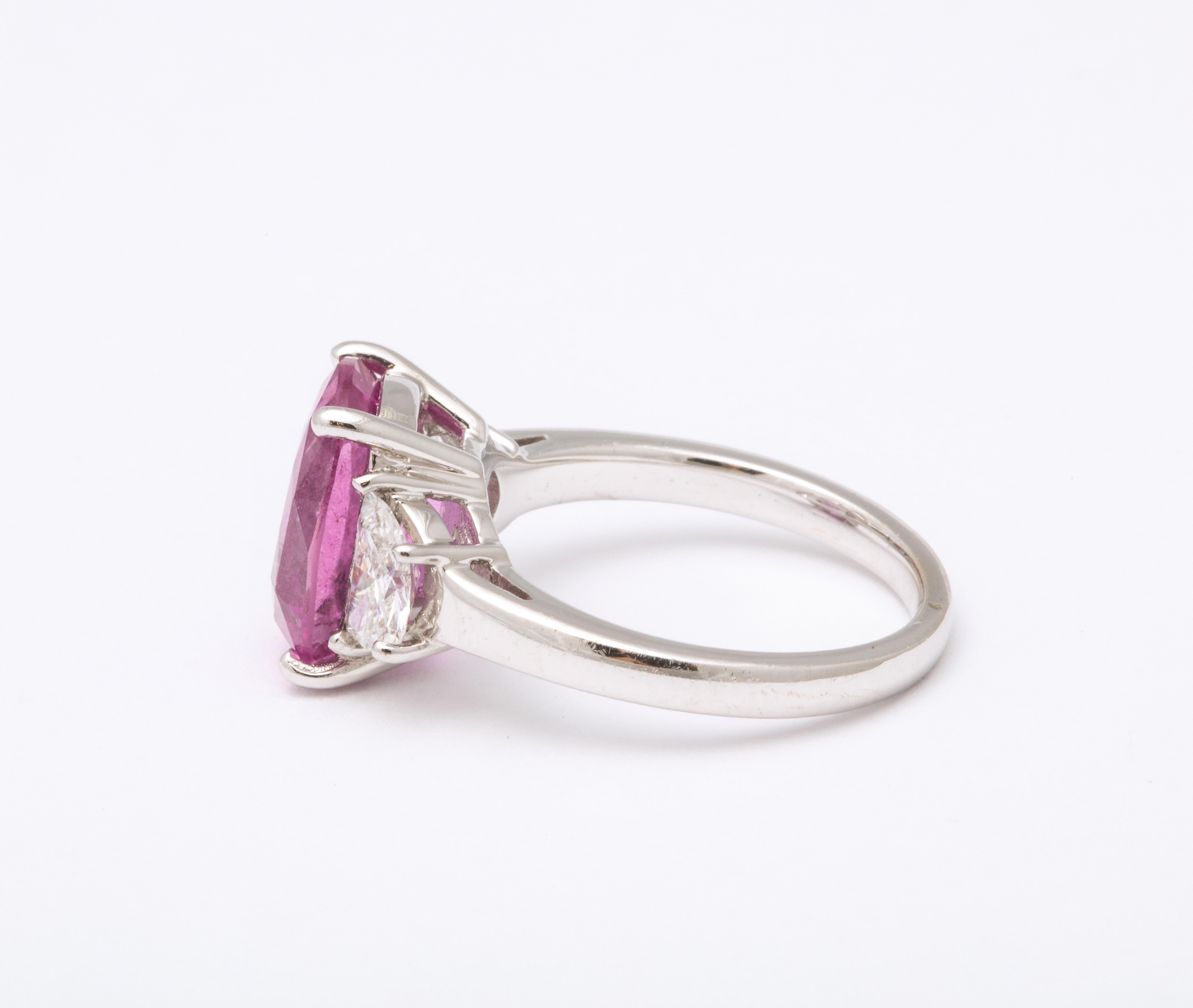 
Certified Vivid Pink Cushion Cut 5.06 carat sapphire and diamond ring. 

.75 carats of colorless white half moon cut diamonds

set in 18k white gold.

Certified by C. Dunaigre Consulting: the sapphire is rated VERY GOOD and VIVID PINK.

Currently a
